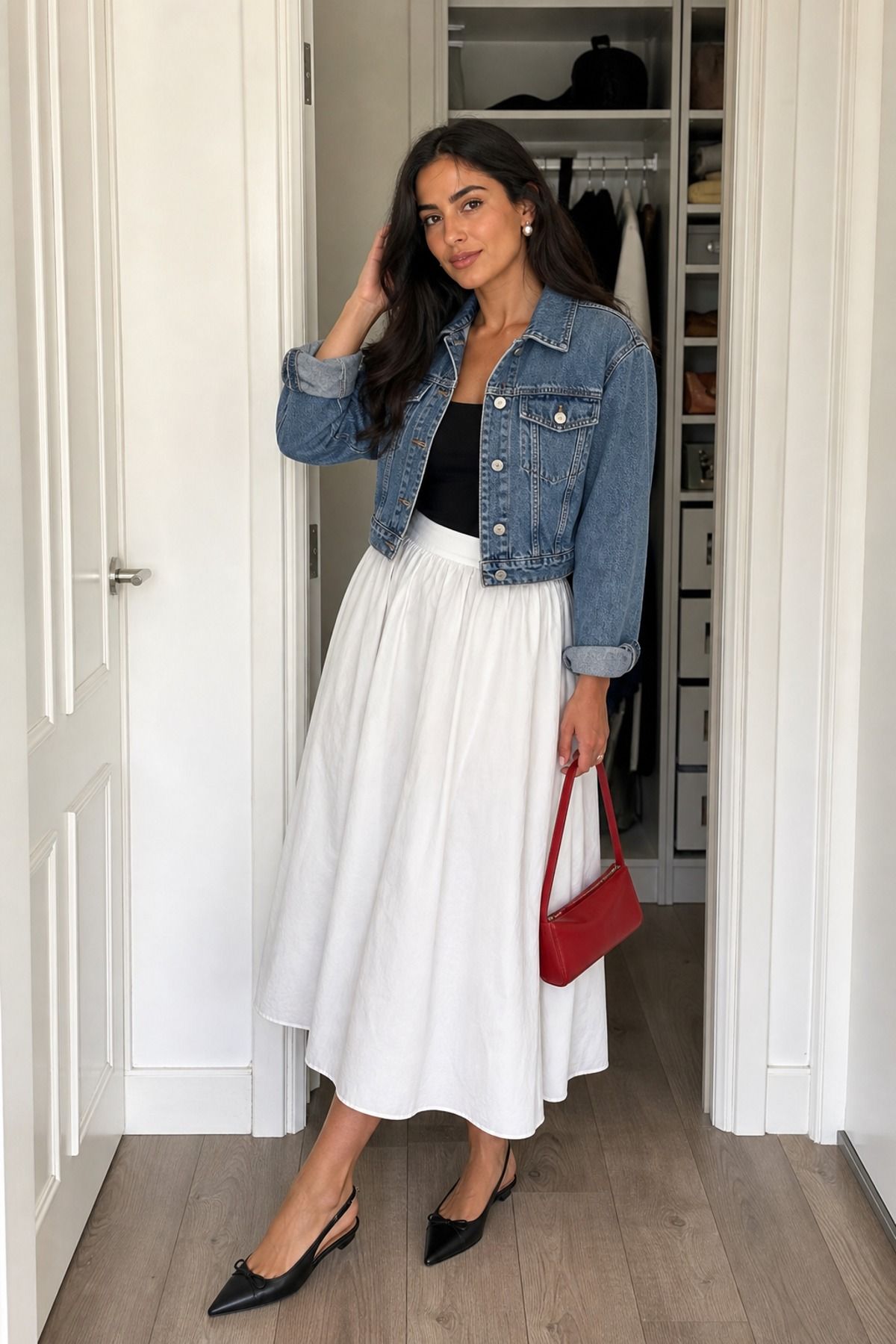 Woman wearing a denim jacket with a white poplin skirt