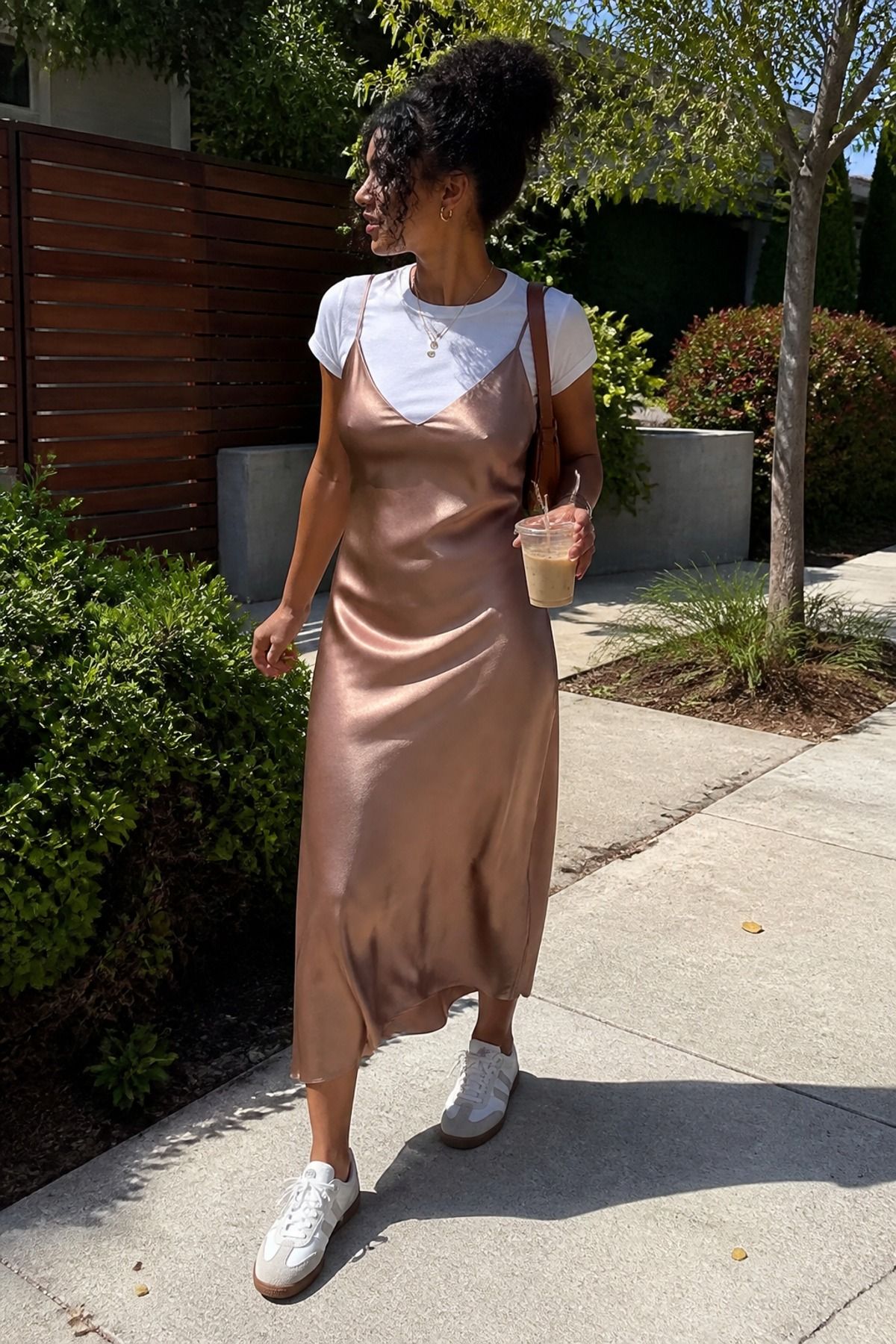 Woman wearing a slip dress with retro sneakers