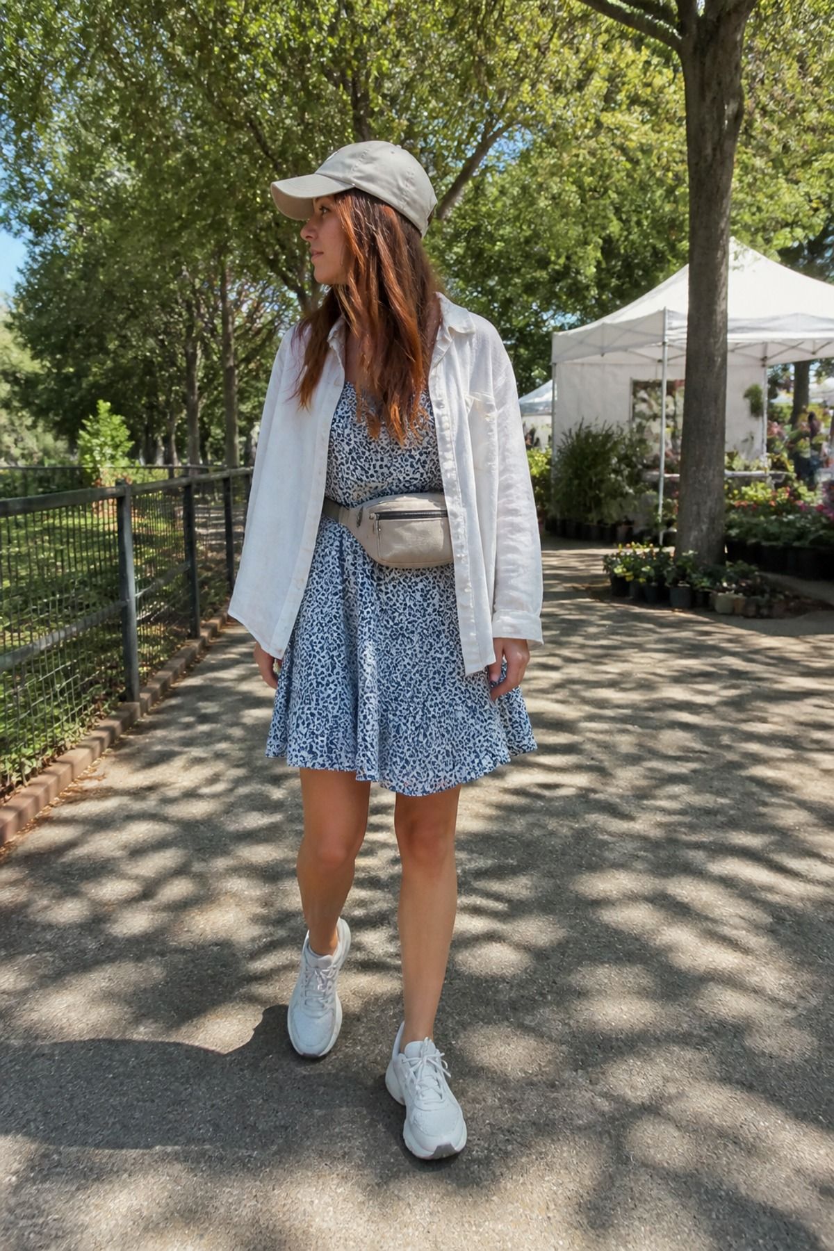 Woman wearing a summer dress with running sneakers