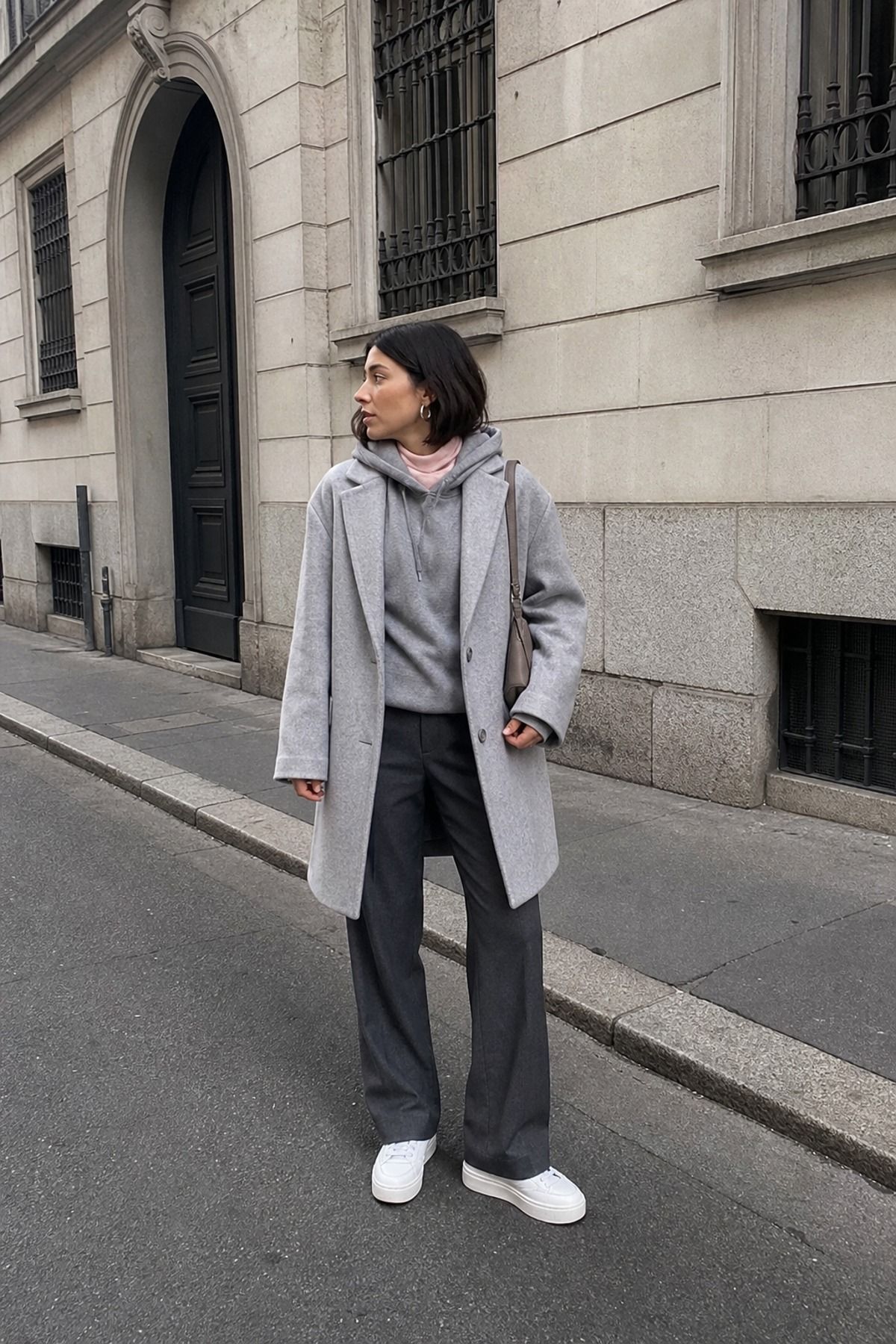 Woman wearing a monochrome hoodie outfit with a wool coat
