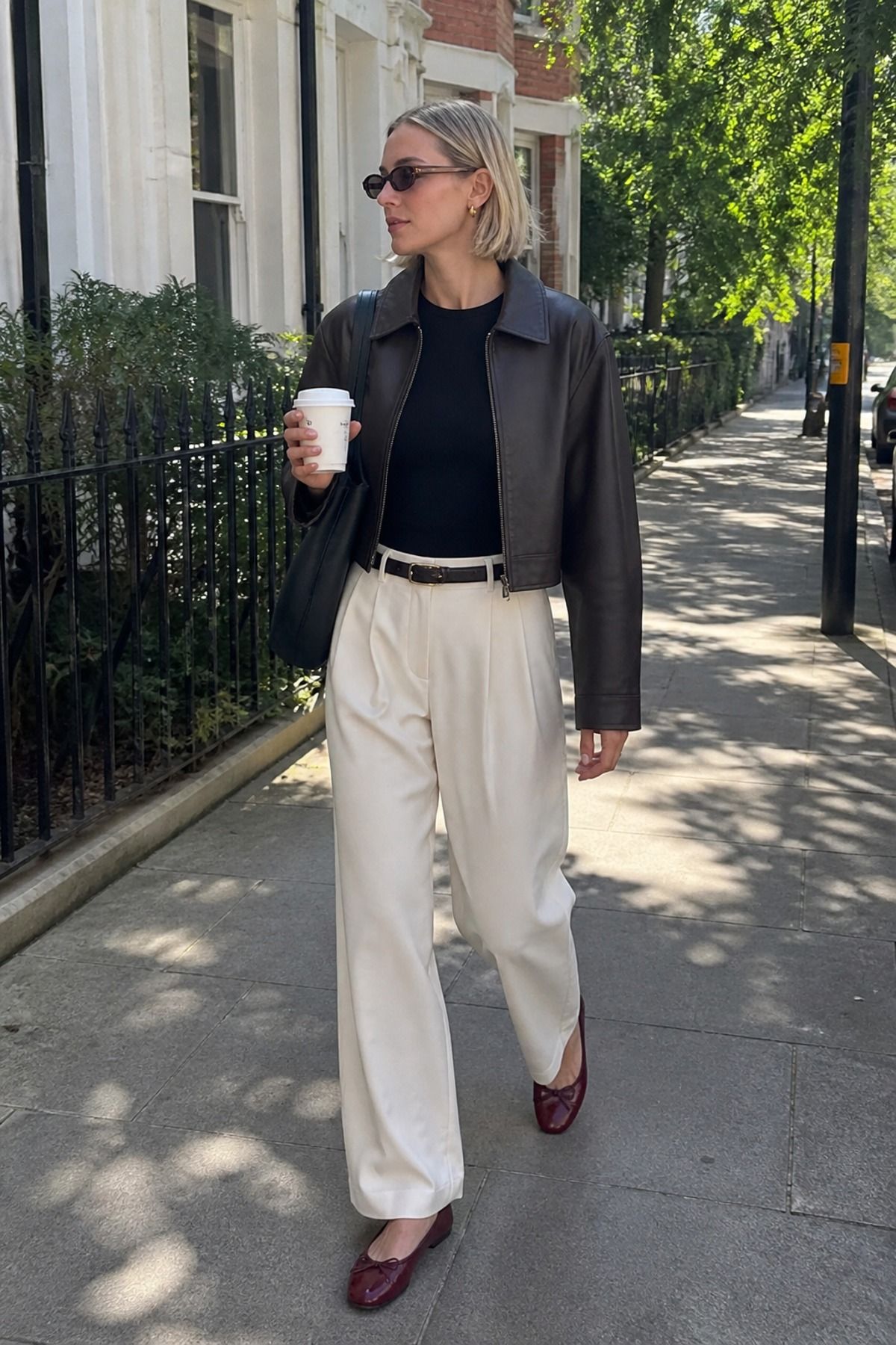 Woman wearing a cropped leather jacket with wide-leg trousers