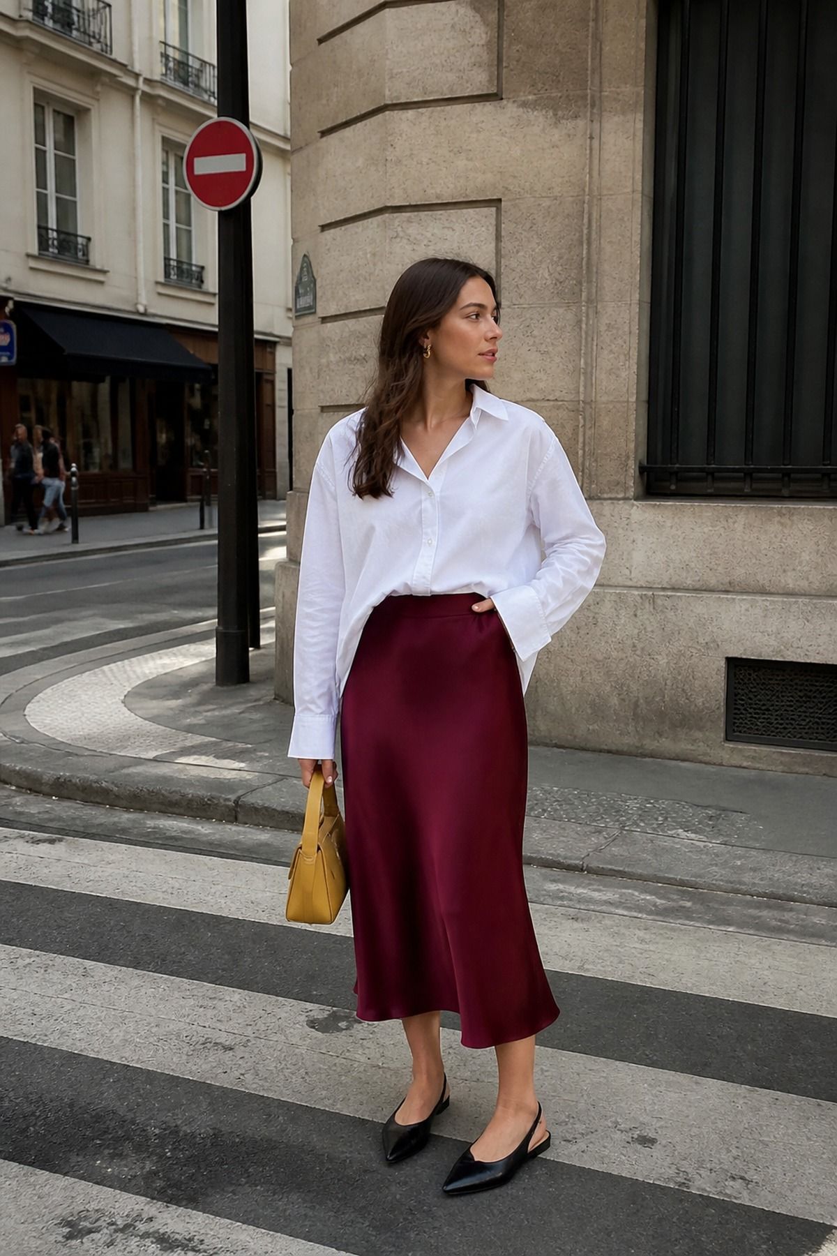 Woman wearing an oversized shirt tucked into a midi skirt