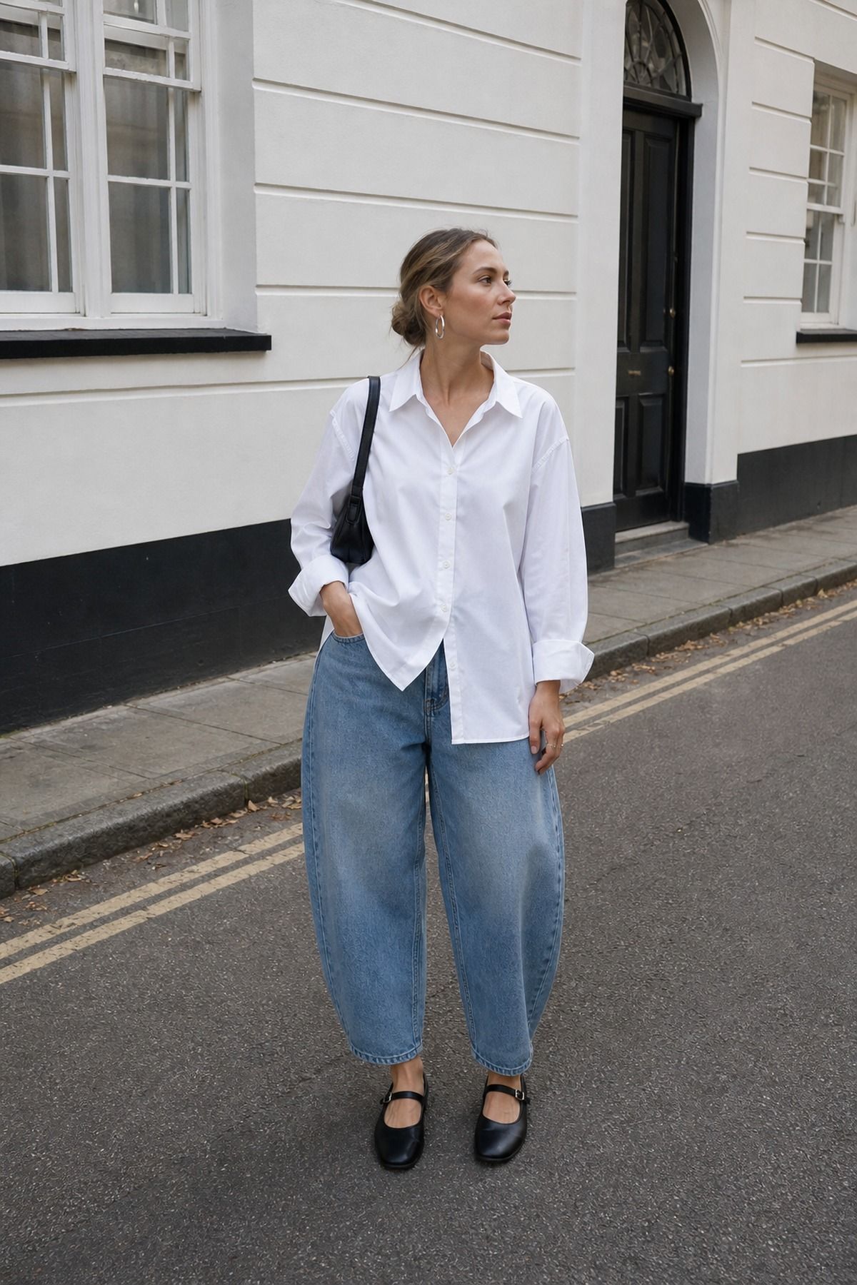Woman wearing an oversized shirt with barrel jeans