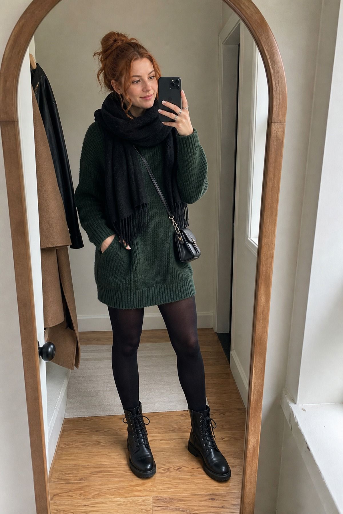 Woman wearing a sweater dress with combat boots
