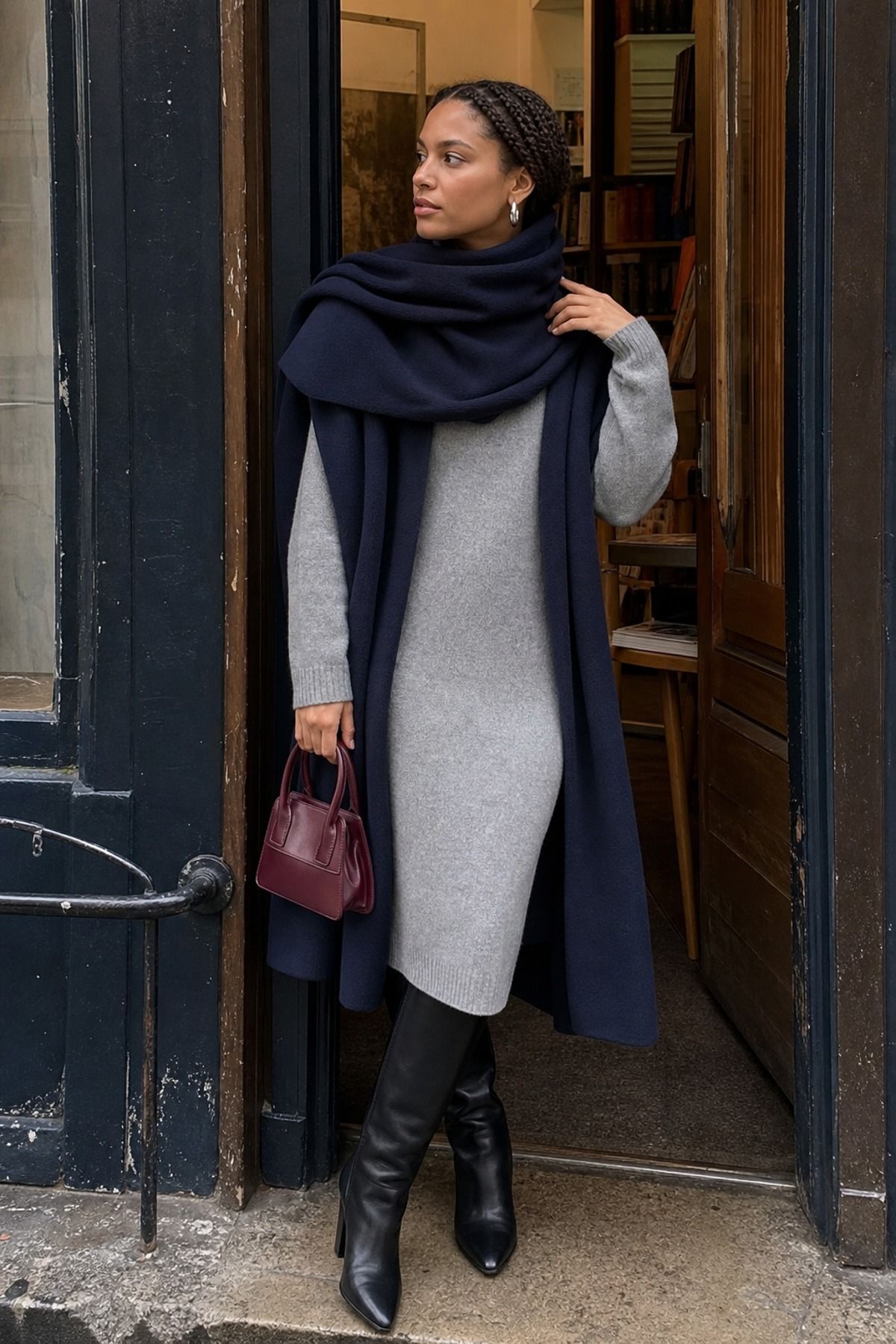 Woman wearing a sweater dress with a scarf coat