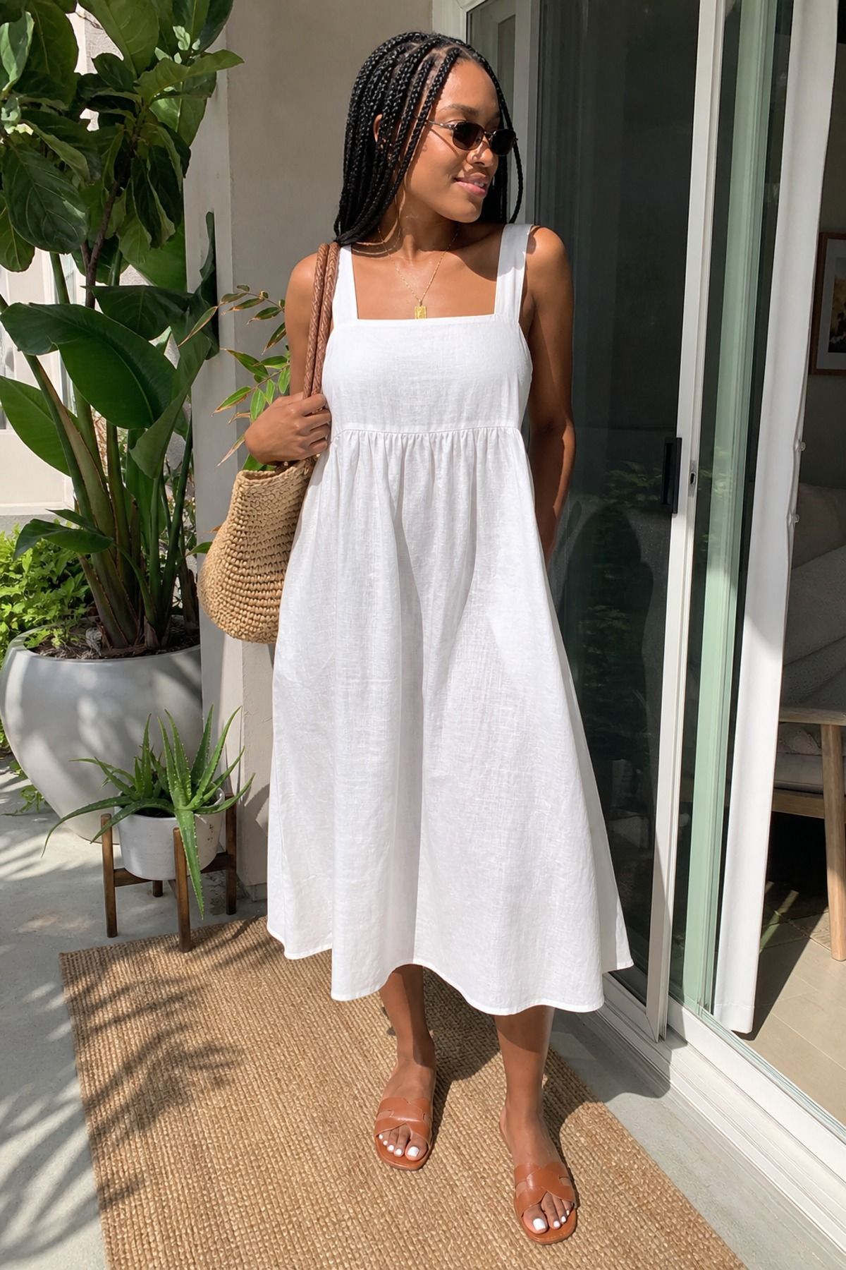 Woman wearing a white linen dress with slides, a white dress outfit
