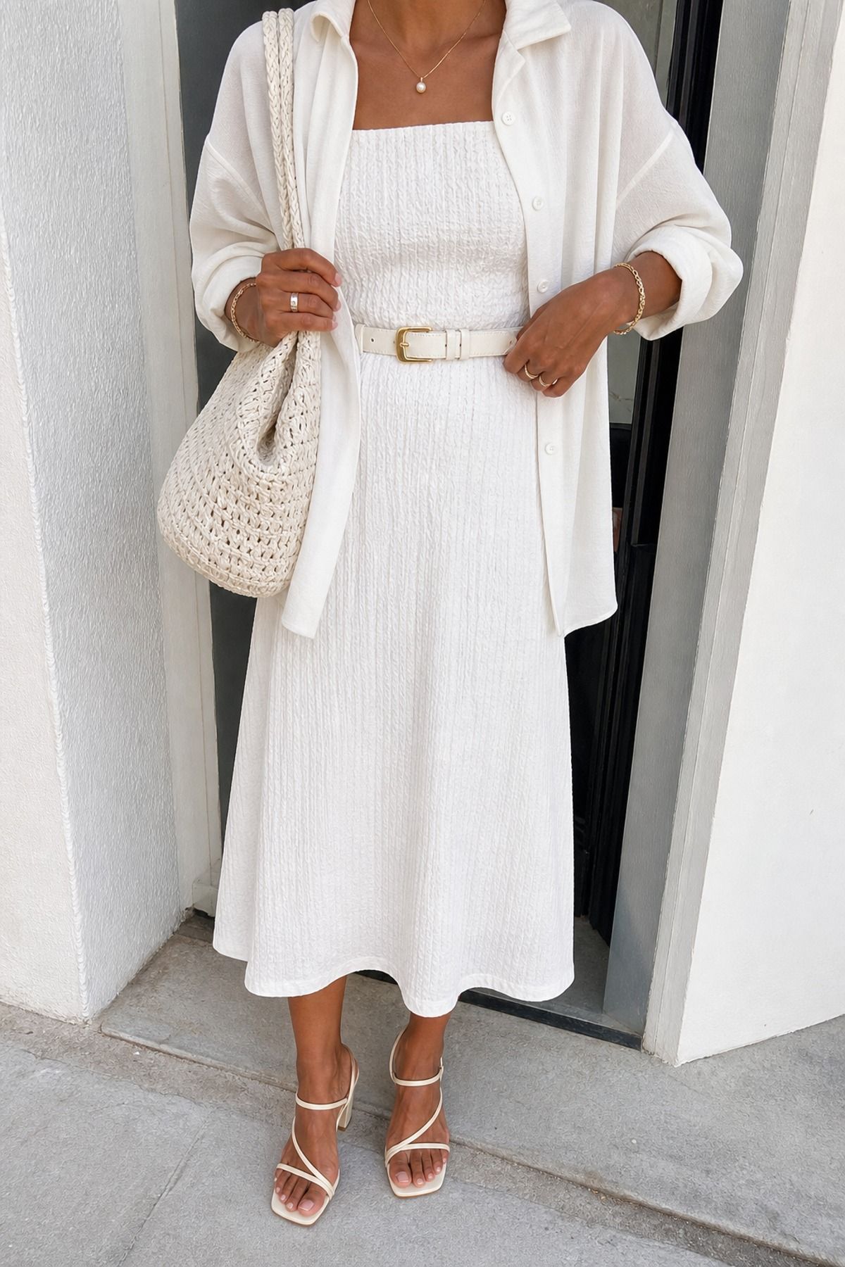 Woman wearing a monochrome white dress outfit with texture