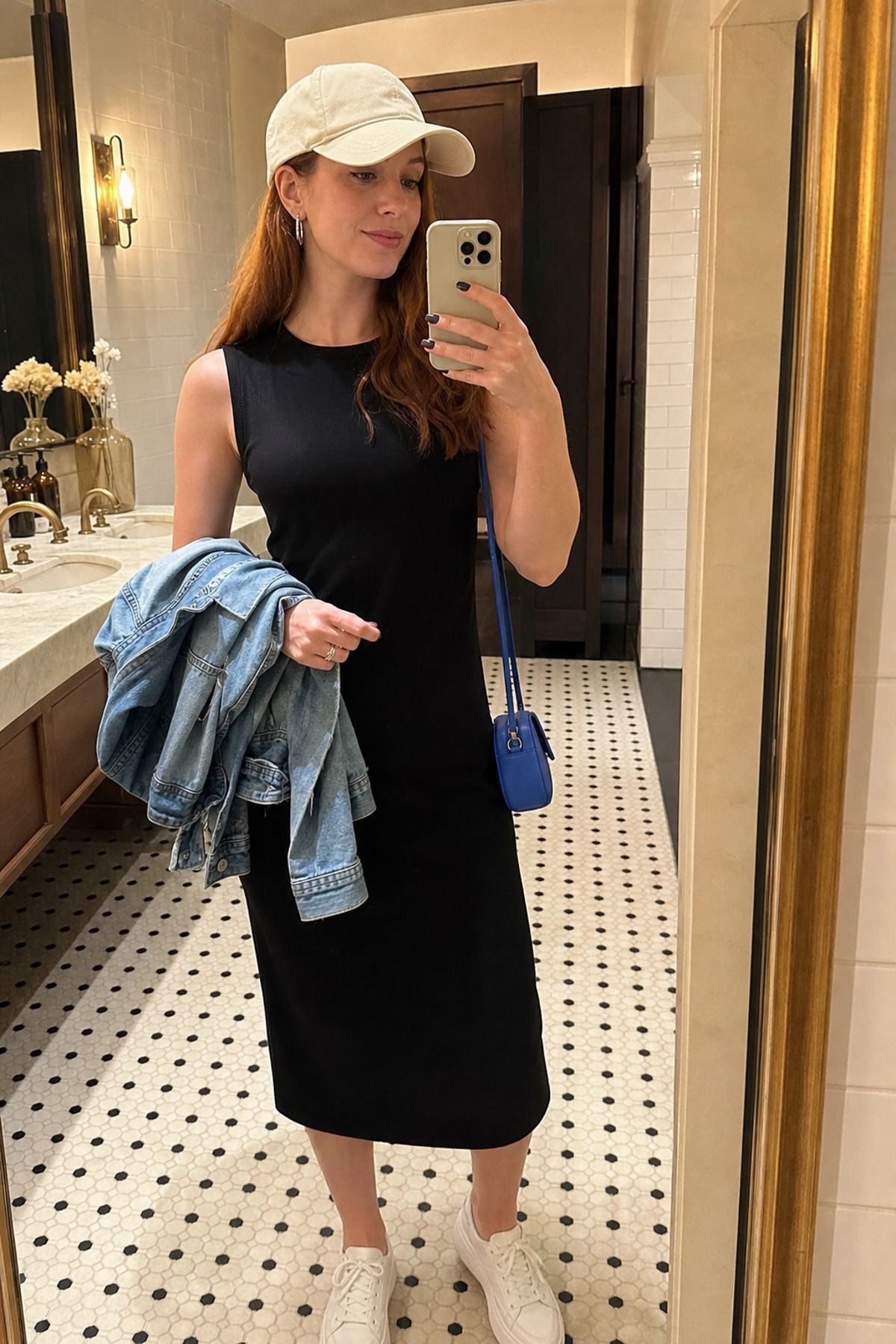 Woman wearing a black dress with a baseball cap