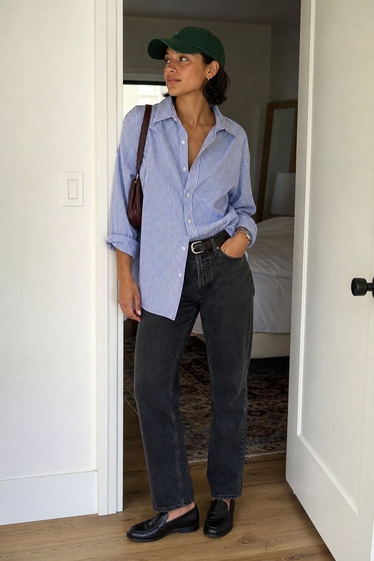 Woman wearing a button-down shirt with a baseball cap