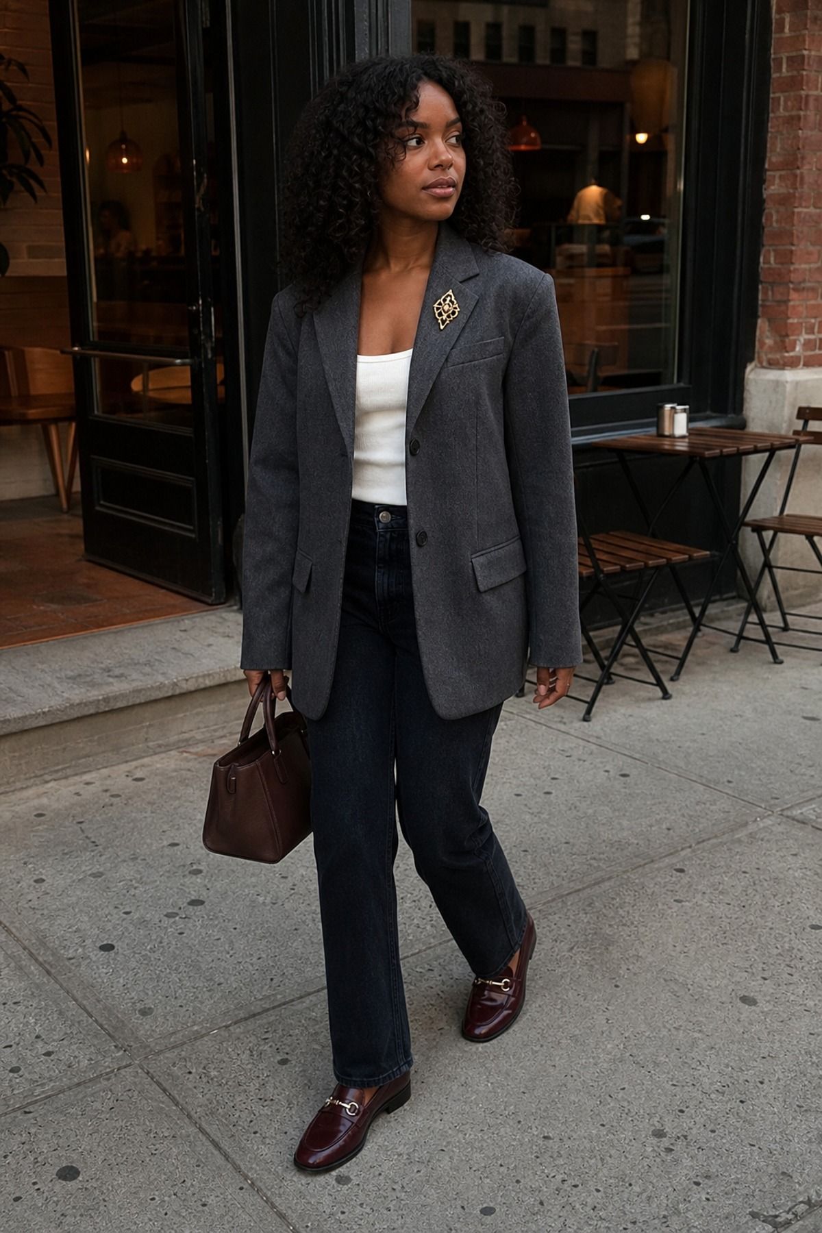 Woman wearing a blazer with a brooch on the lapel