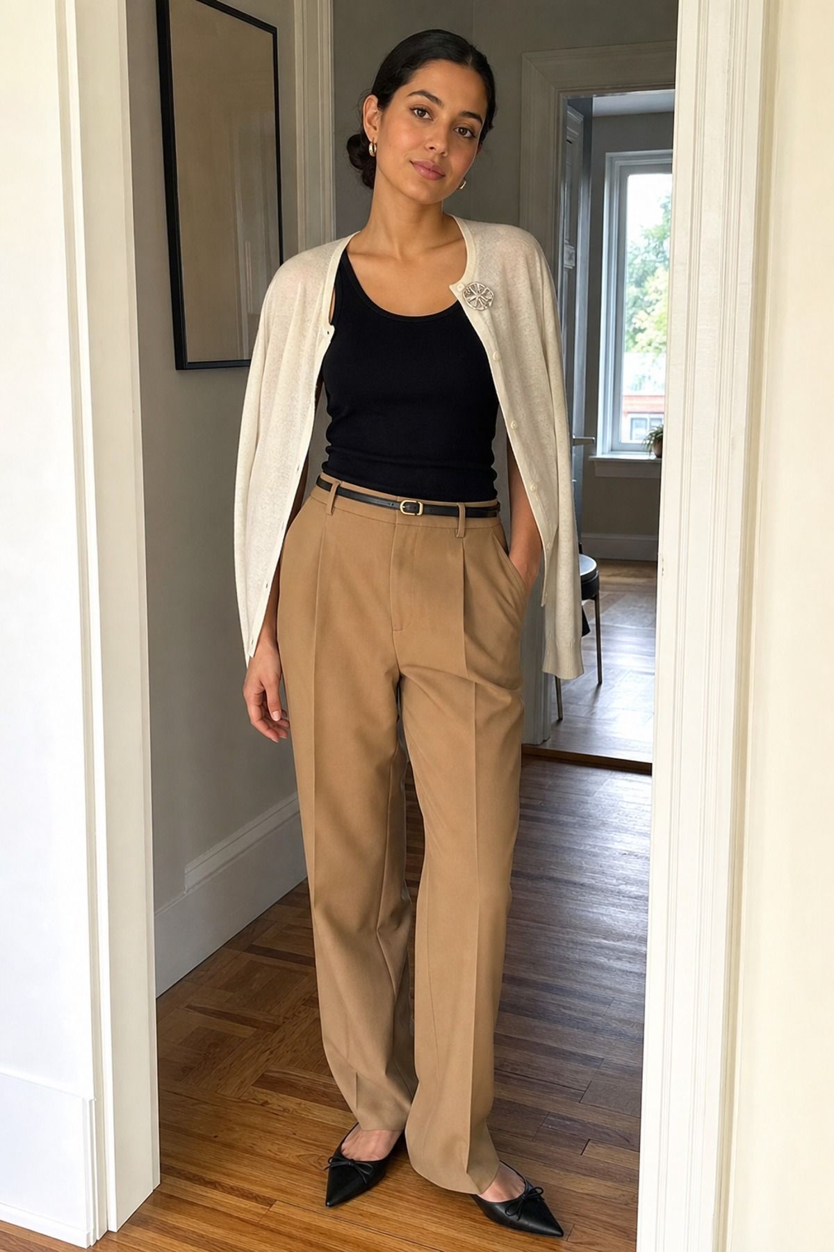 Woman wearing a tank top and trousers with a brooch