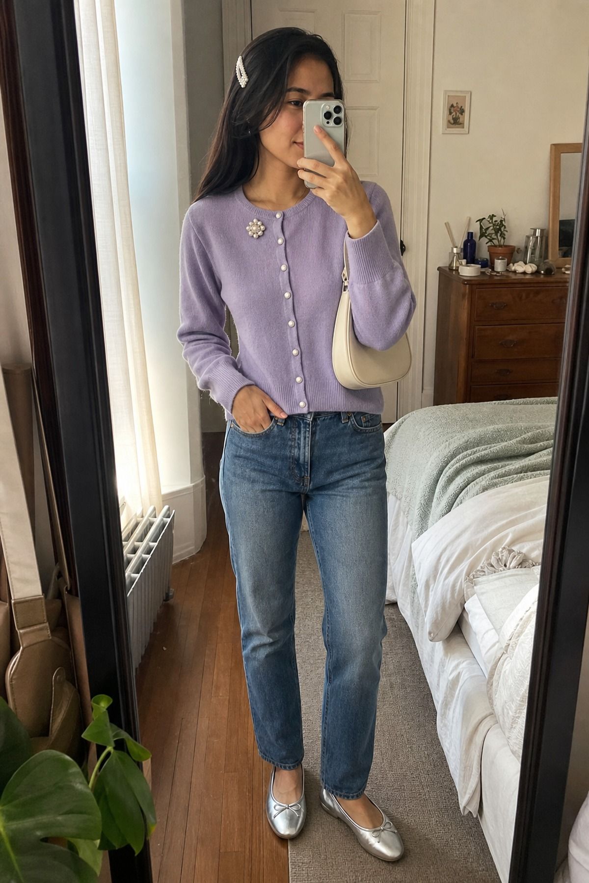 Woman wearing a cardigan and jeans with a brooch