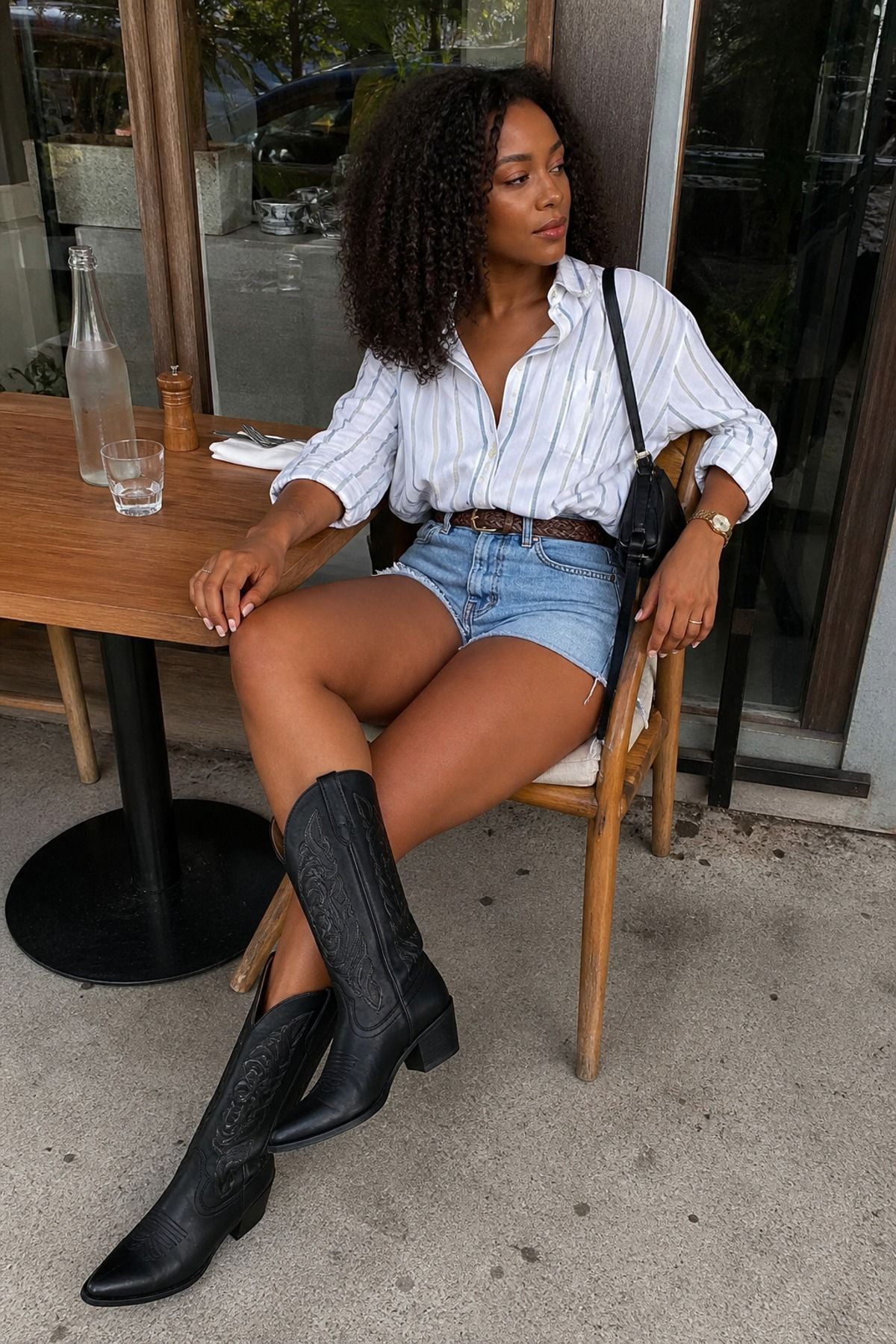 Woman wearing denim shorts with cowboy boots