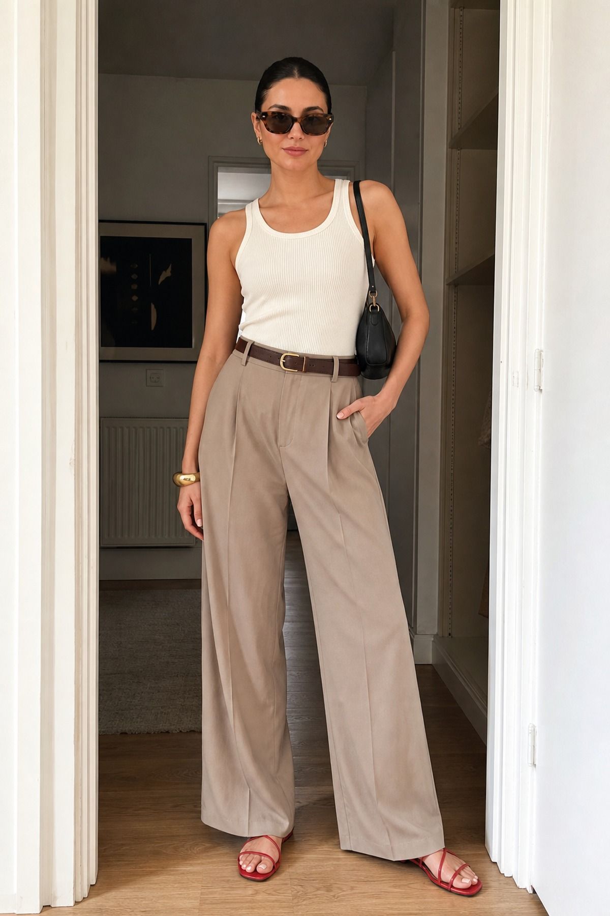 Woman wearing a ribbed tank with wide leg trousers, a French girl casual outfit