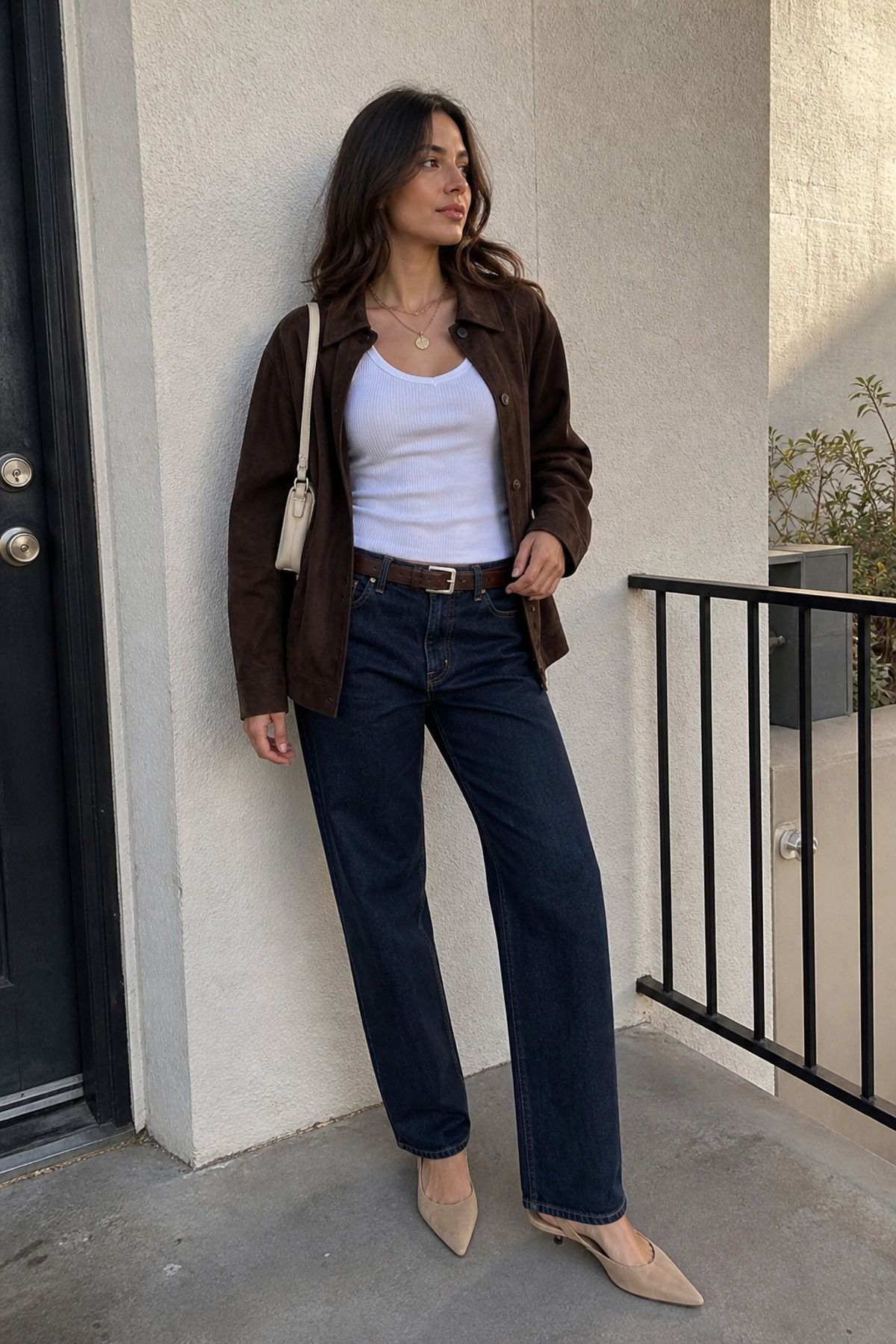 Woman wearing a suede jacket with a white tank, a French girl casual outfit