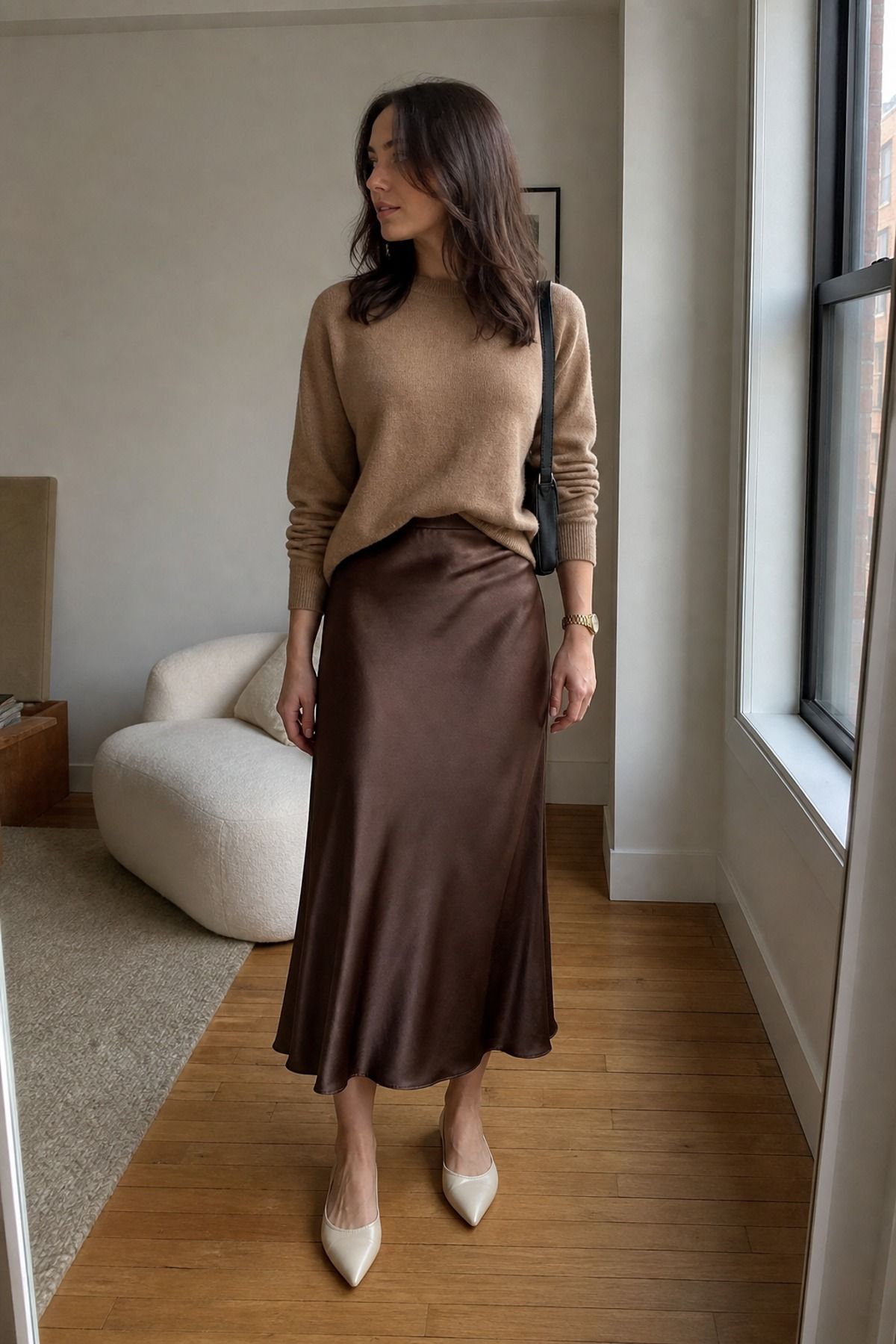 Woman wearing a cashmere sweater with a satin skirt, a French girl casual outfit
