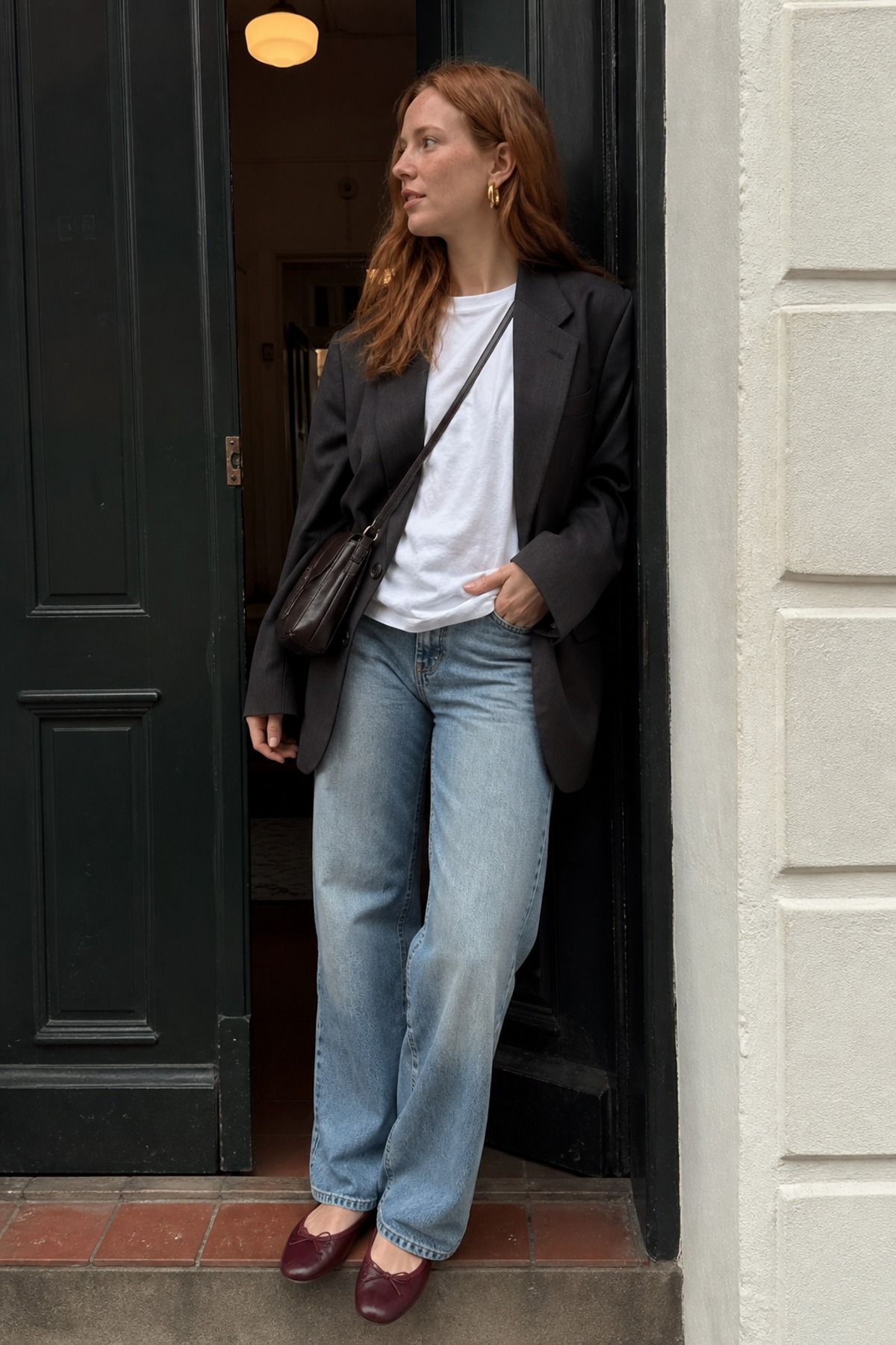 Woman wearing a blazer outfit with gold jewelry
