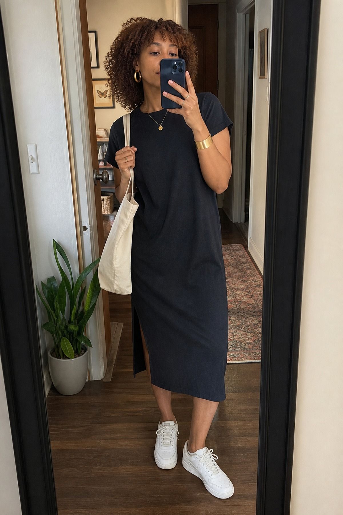Woman wearing a t-shirt dress with gold jewelry