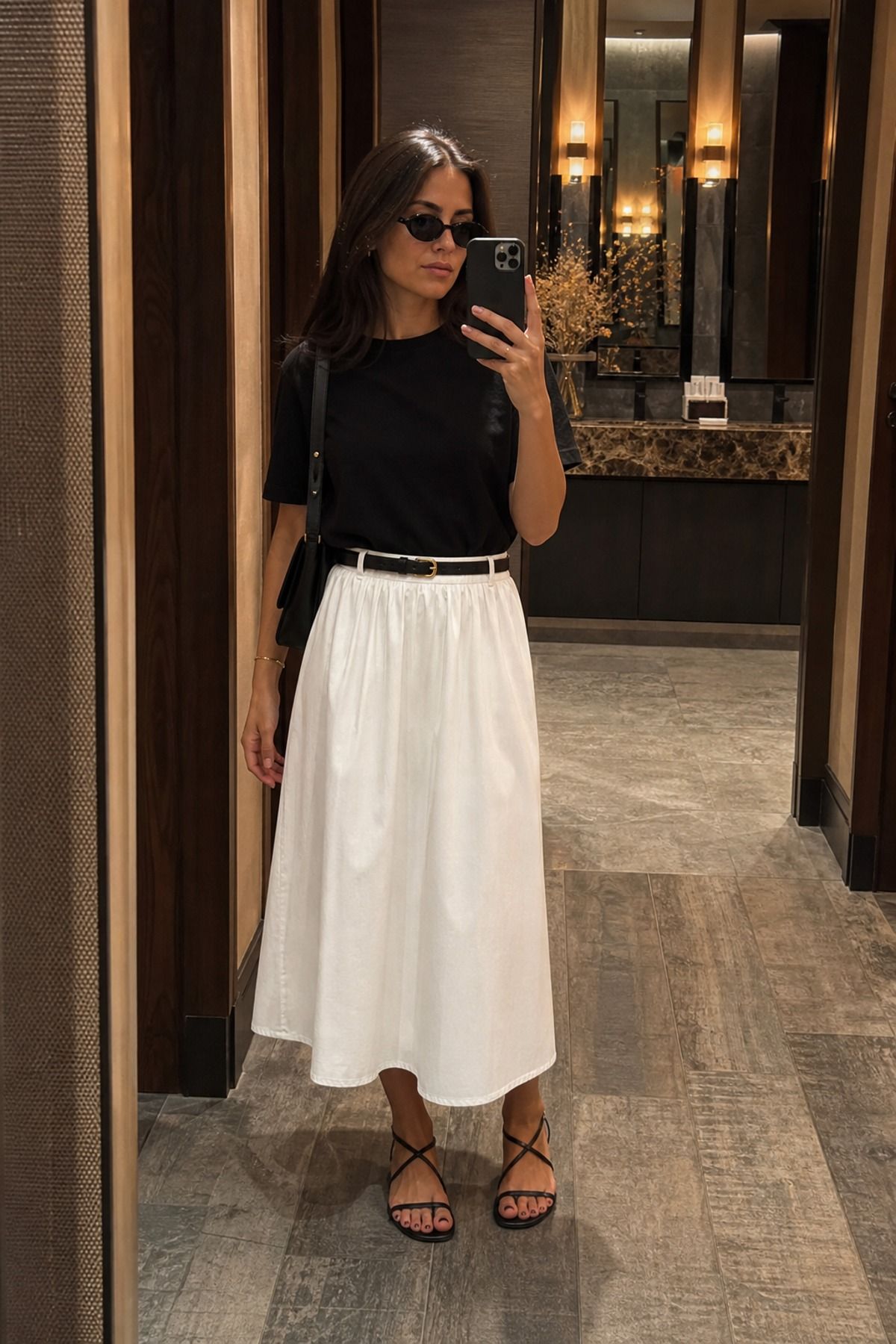 Woman wearing a white skirt with a black tee, a minimalist outfit