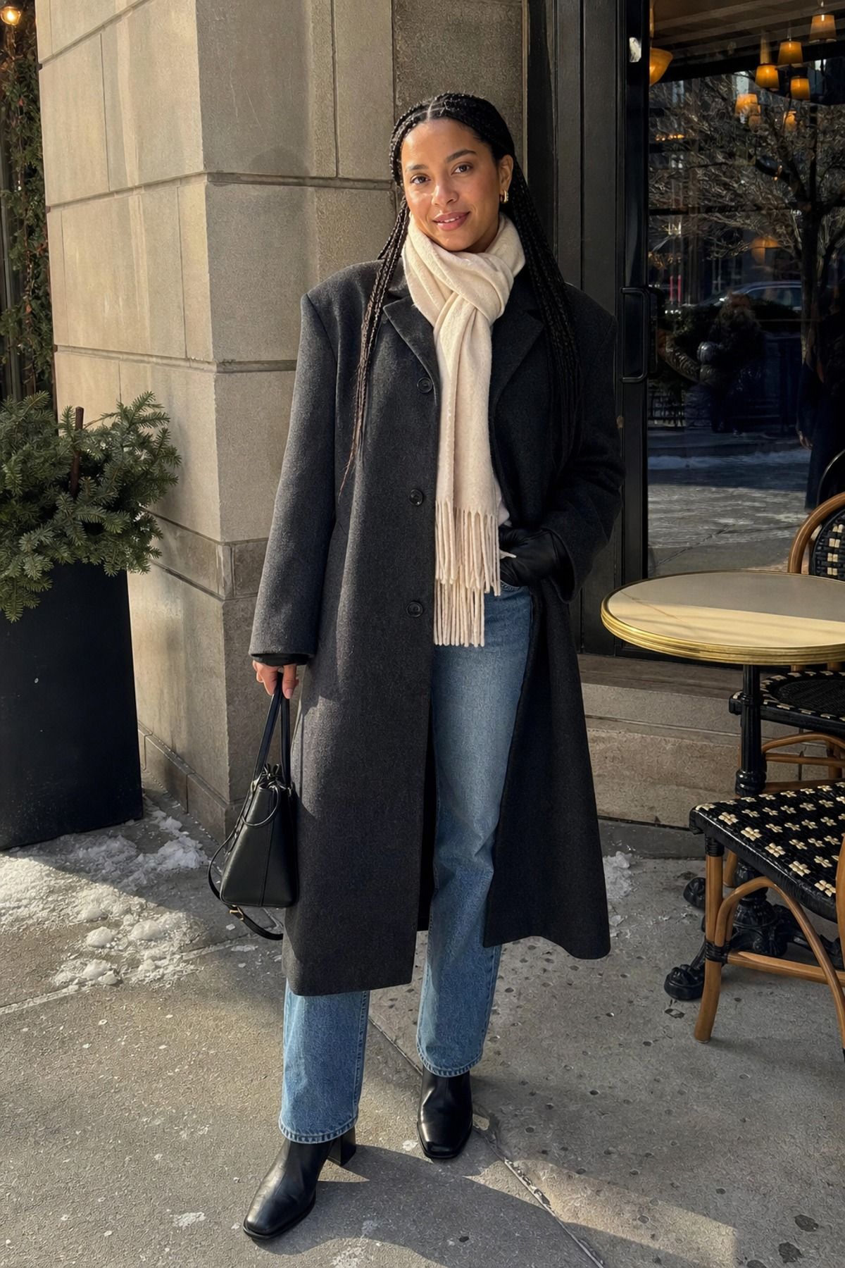 Woman wearing a winter wool coat with straight jeans