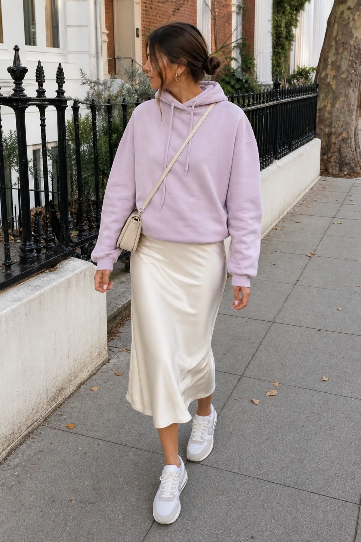 Woman wearing a soft hoodie with a satin skirt, a soft girl outfit