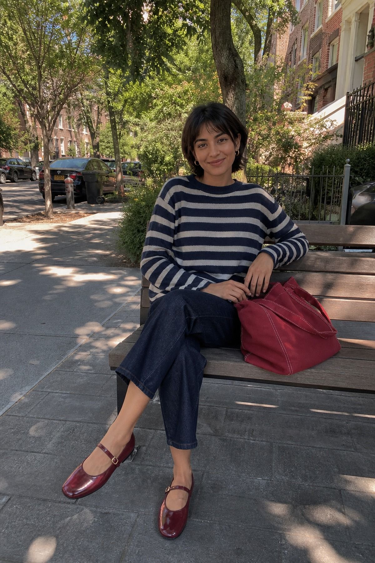 Woman in a striped sweater outfit carrying a plain tote bag