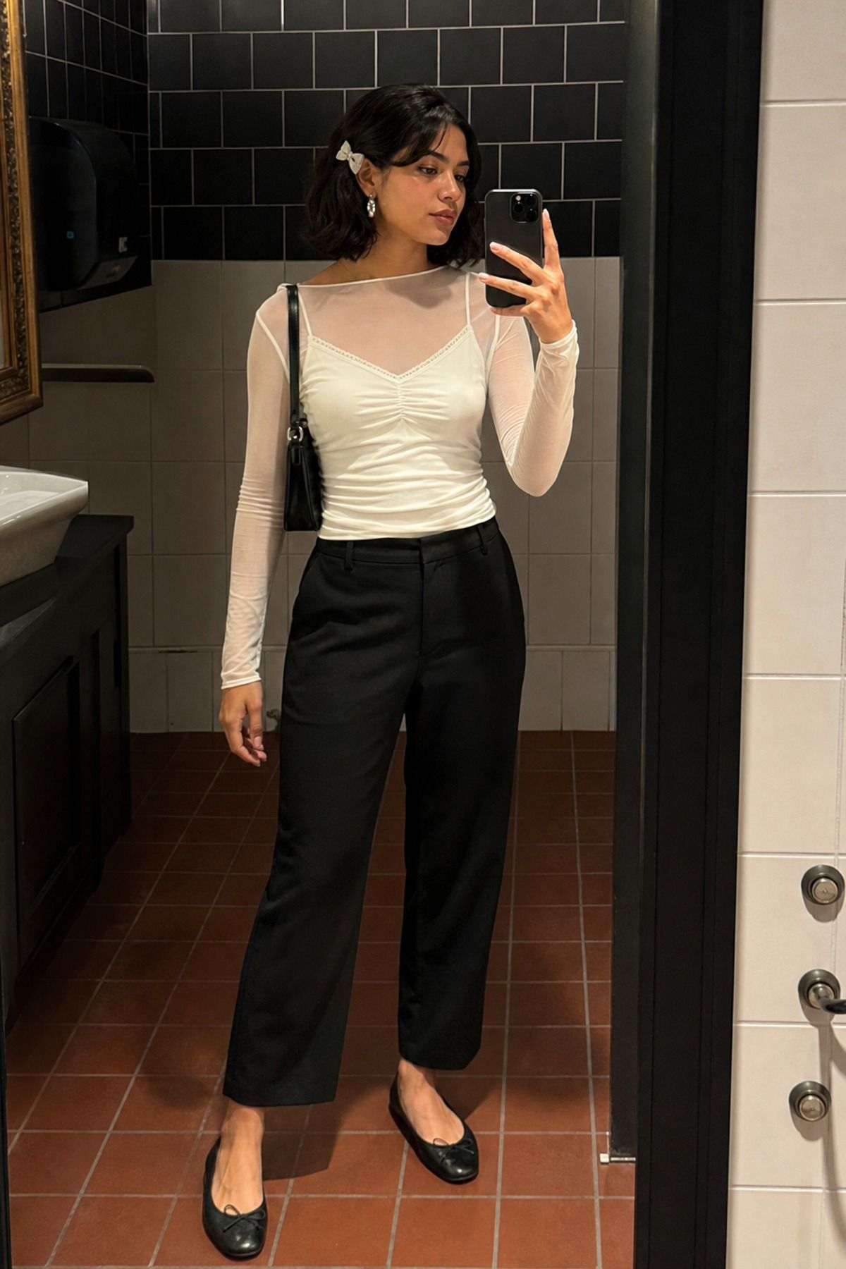 Woman wearing a mesh long sleeve with a camisole and trousers, a balletcore casual outfit