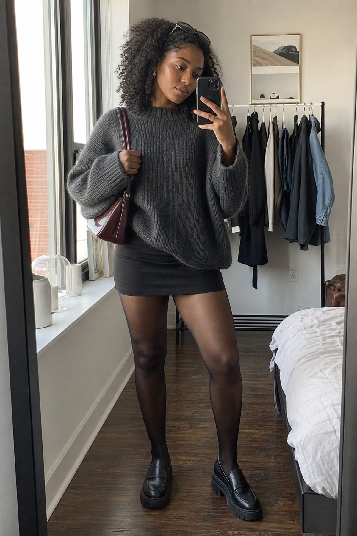 Woman wearing a mini skirt with an oversized sweater, a downtown girl outfit