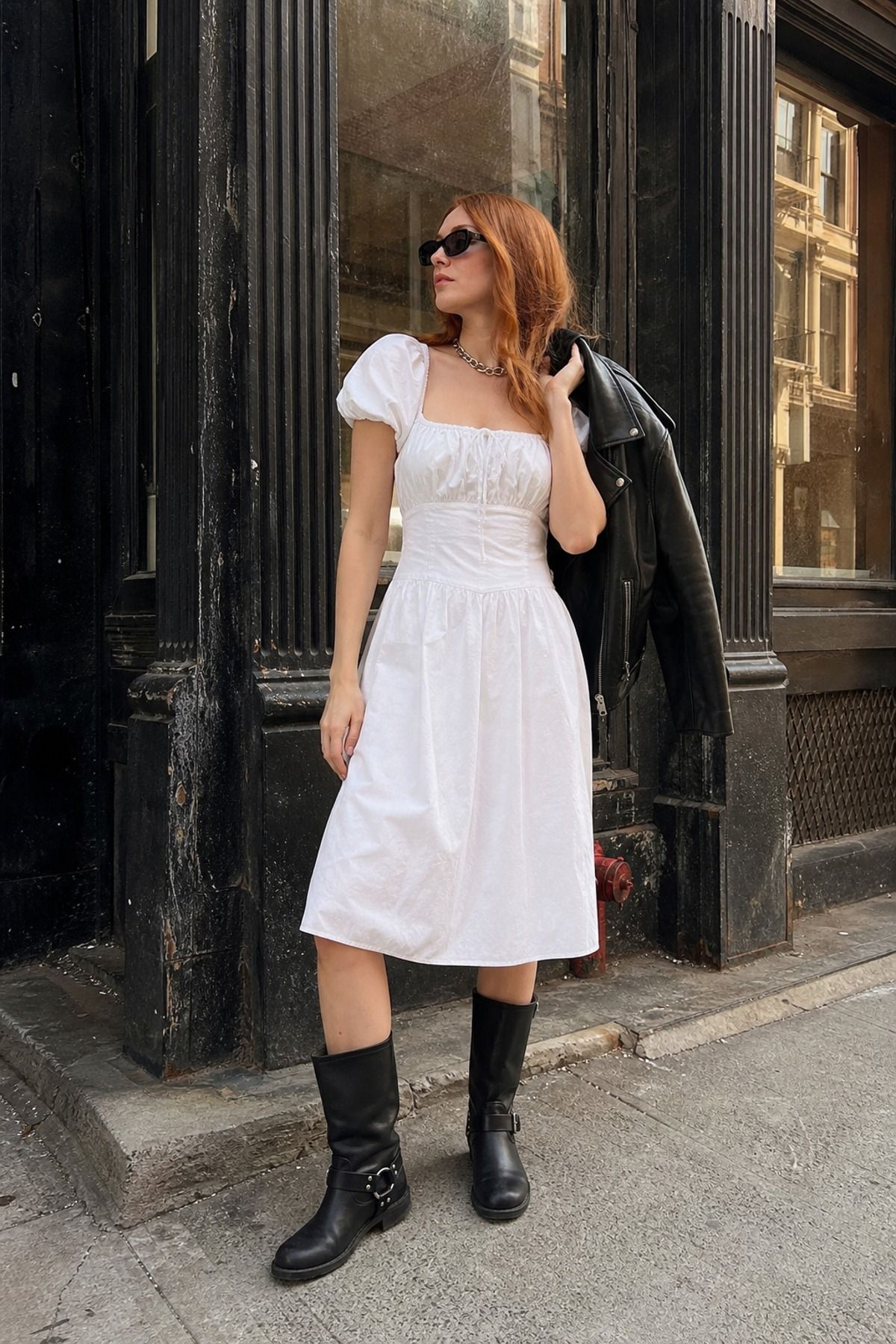 Woman wearing moto boots with a cotton dress, a downtown girl outfit