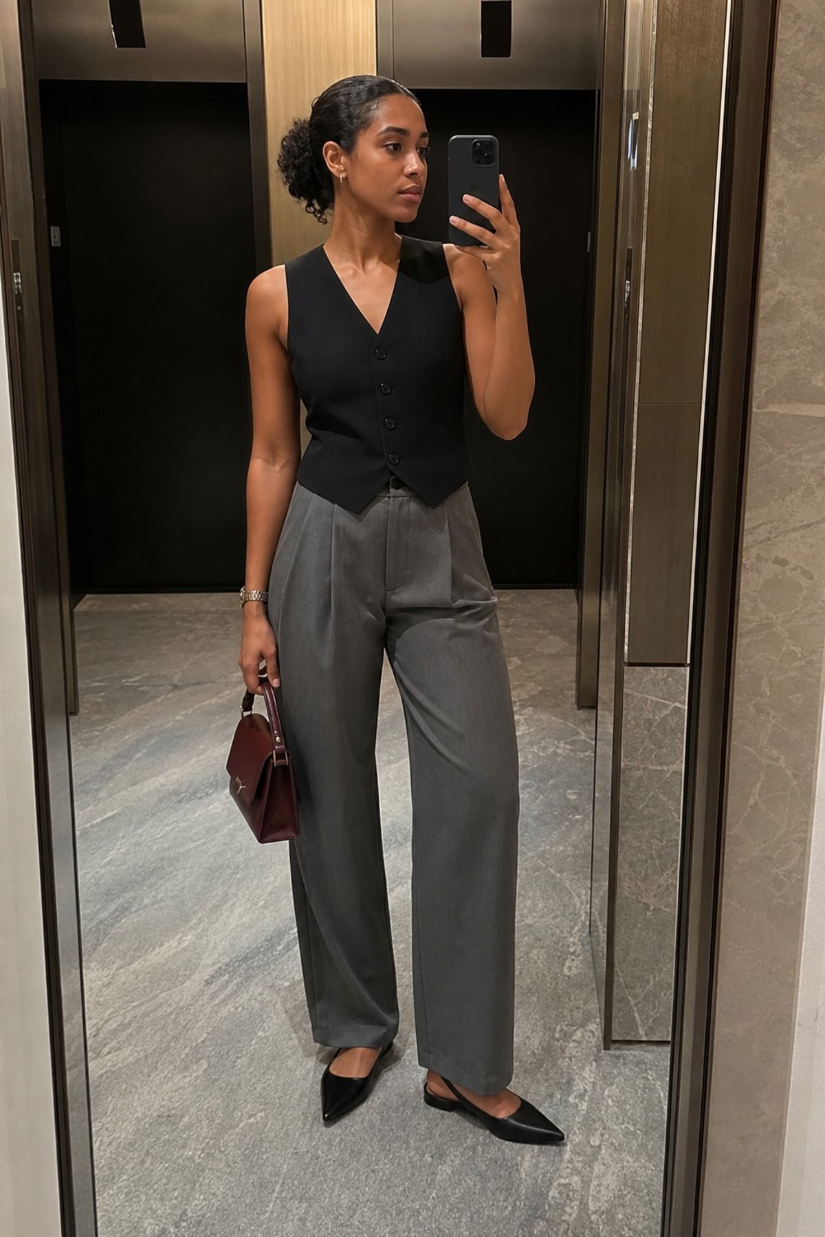 Woman wearing a vest top with tailored trousers, a downtown girl outfit