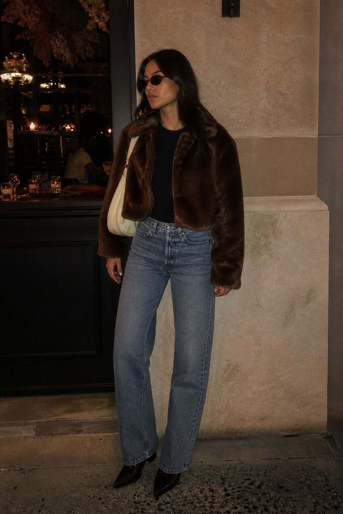 Woman wearing a faux fur jacket with vintage jeans, a downtown girl outfit