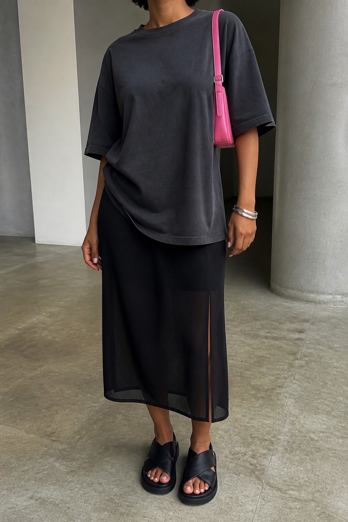Woman wearing a sheer skirt with an oversized tee, a downtown girl outfit