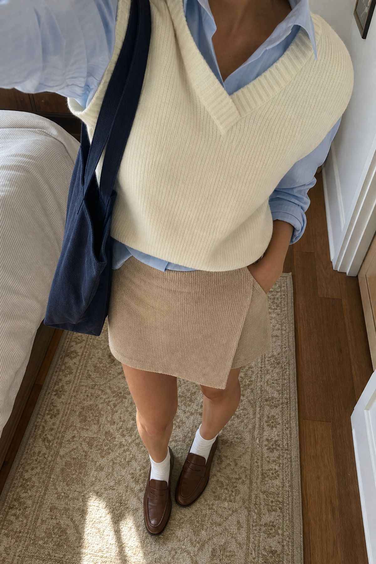 Woman wearing an Oxford shirt with a knit skort, a light academia outfit