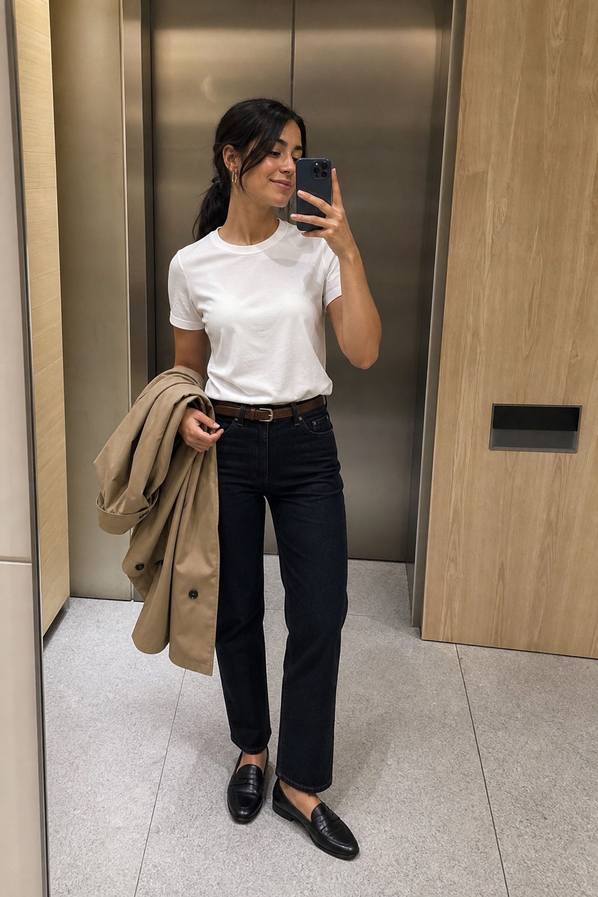 Woman wearing a white tee with dark jeans and loafers, a NYC casual outfit