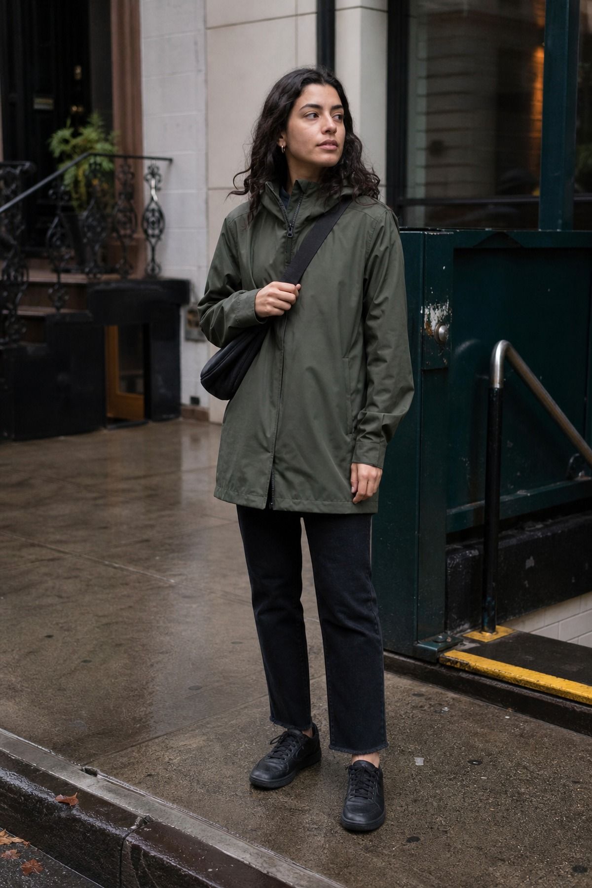Woman wearing a rain jacket with black jeans and waterproof sneakers, a NYC casual outfit