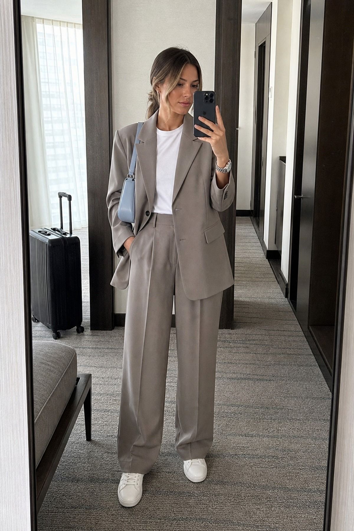 Woman wearing relaxed suiting with minimal sneakers, a Parisian casual outfit