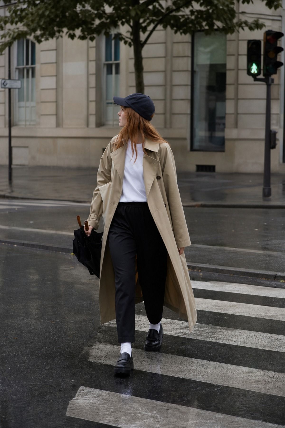 Woman wearing a trench coat with pull-on pants, a Scandinavian style outfit