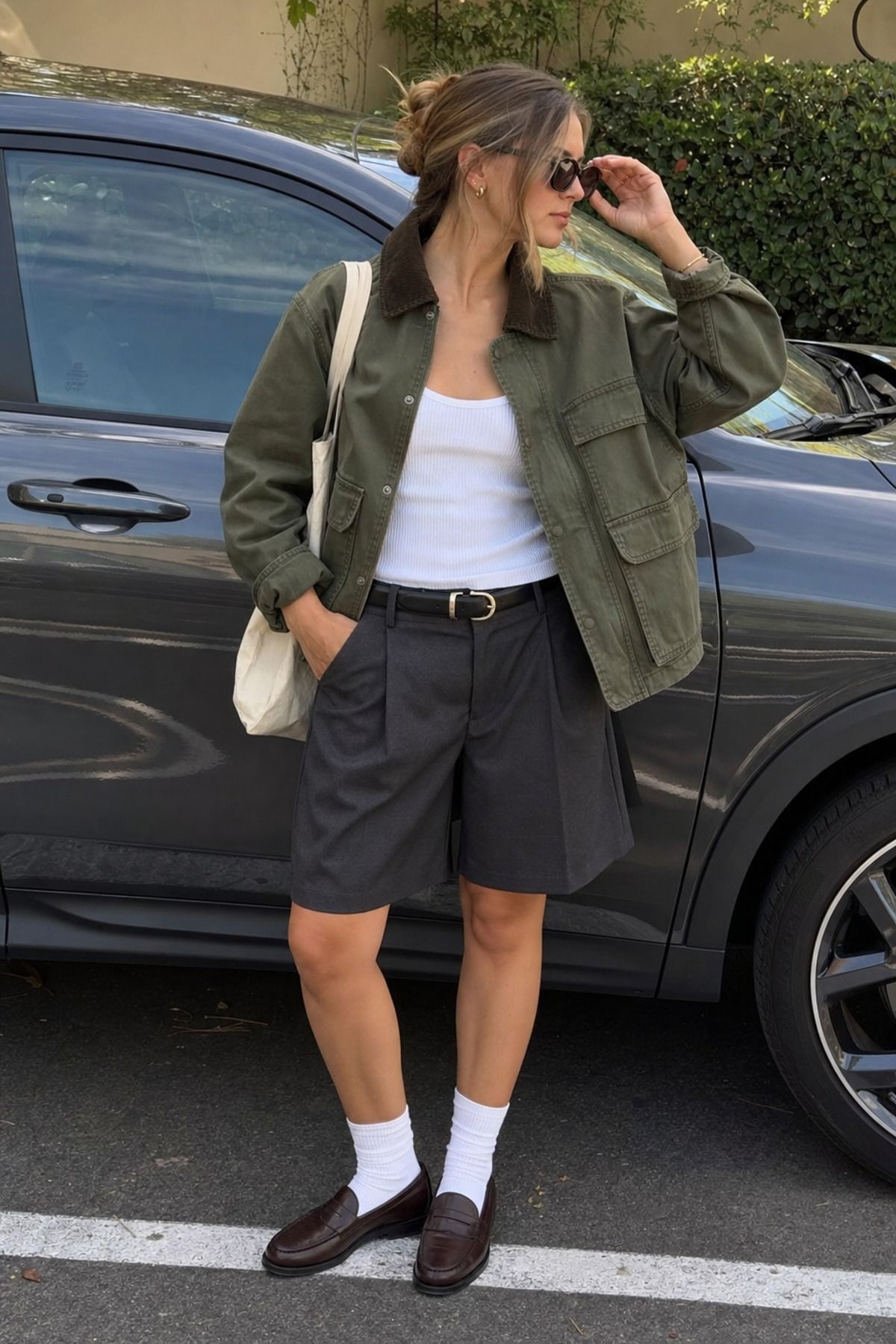 Woman wearing a utility jacket with tailored shorts, a Scandinavian style outfit