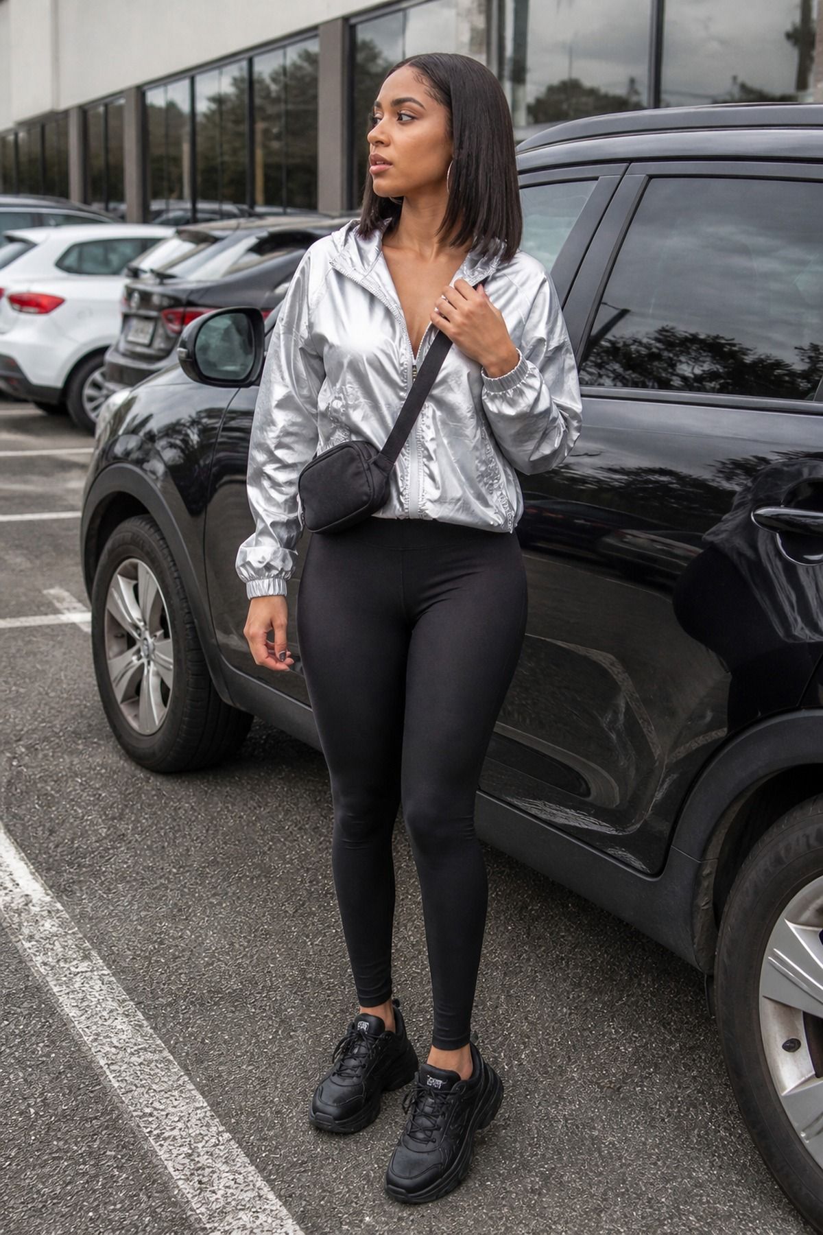Woman wearing a reflective jacket with black leggings, an aliencore outfit