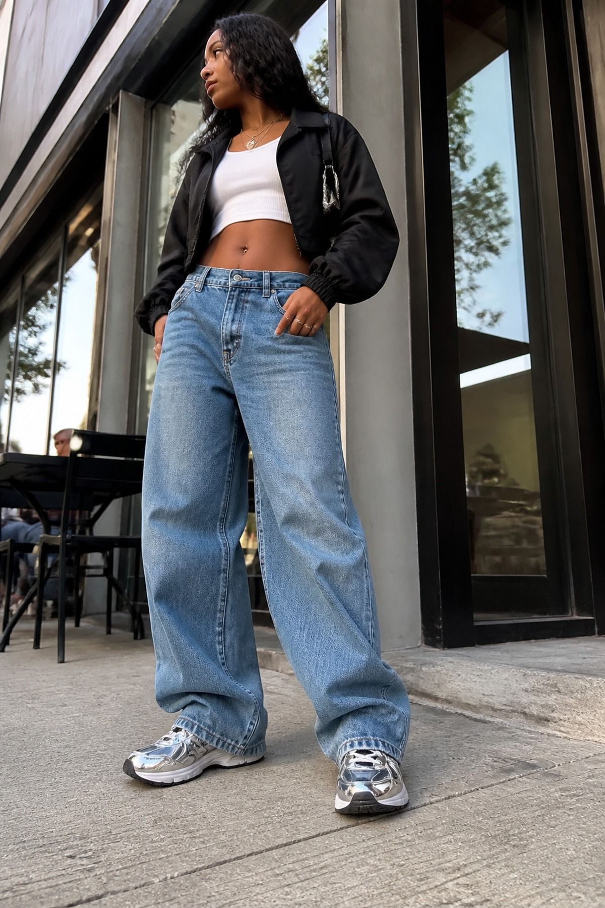 Woman wearing chrome sneakers with baggy denim, an aliencore outfit
