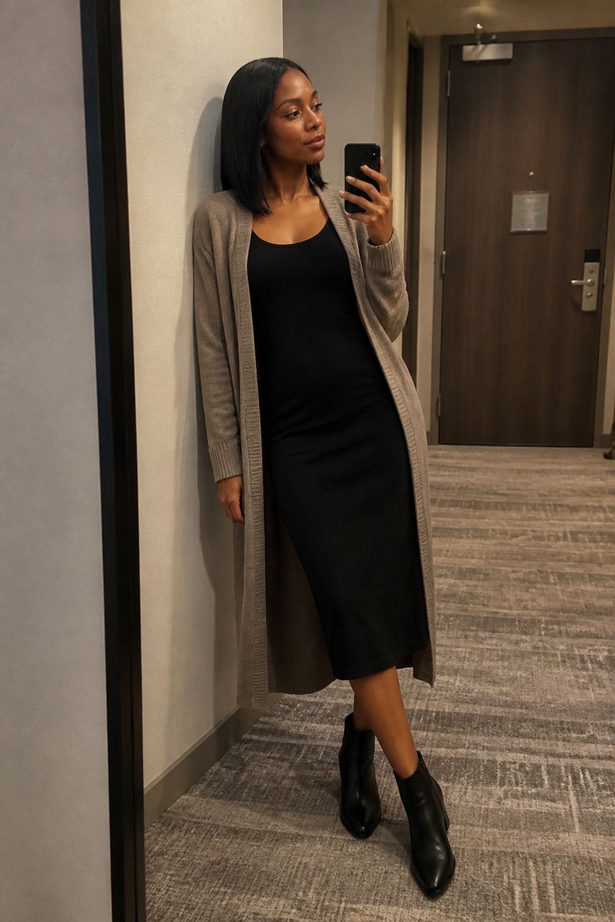 Woman wearing a long cardigan with a column dress