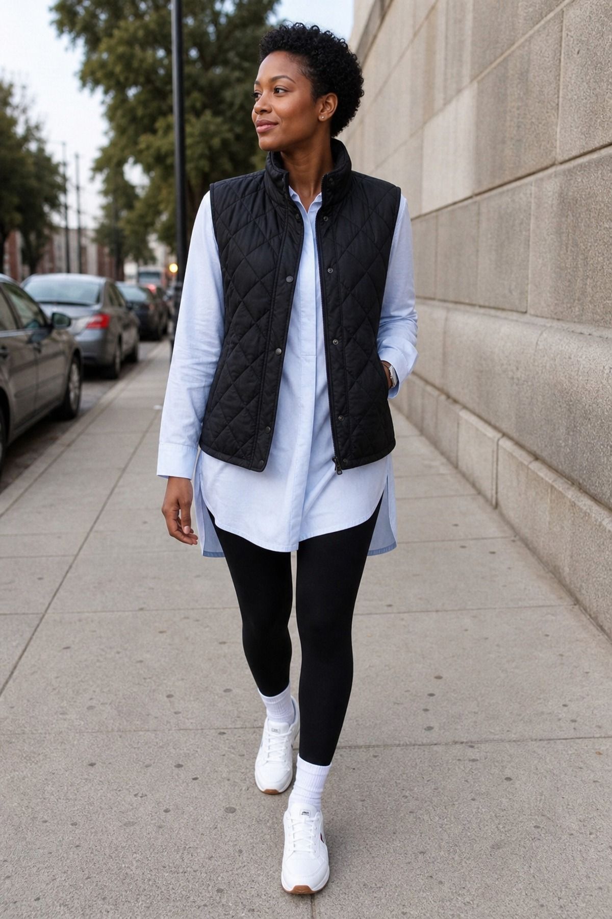 Woman wearing leggings with a tunic shirt and quilted vest
