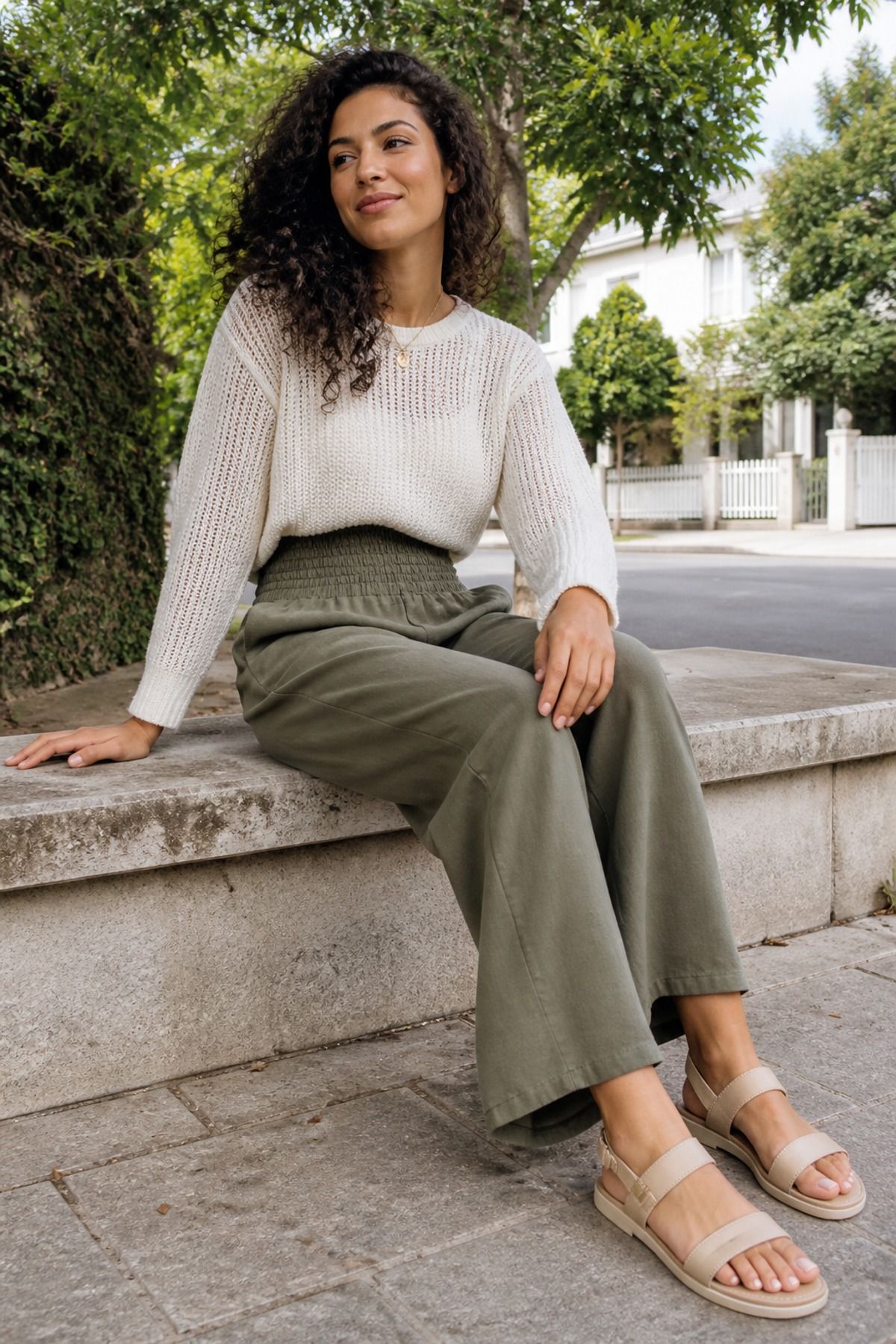Woman wearing smocked-waist pants with a cotton sweater