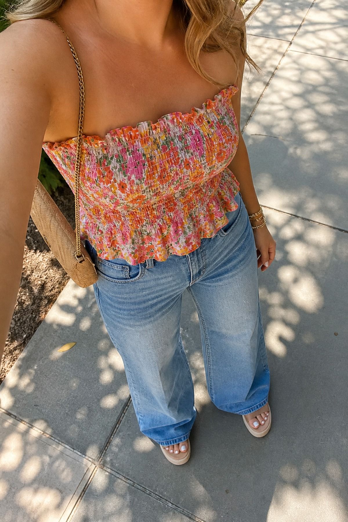 Woman wearing a smocked top with wide-leg jeans