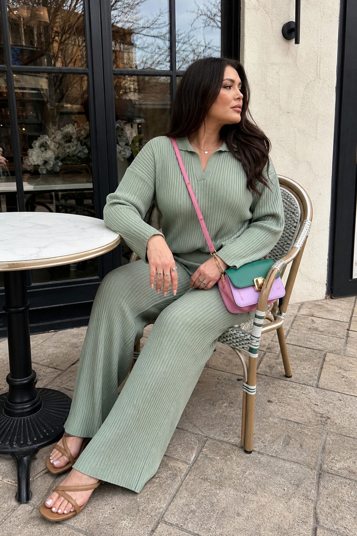 Woman wearing a matching knit set with a crossbody bag