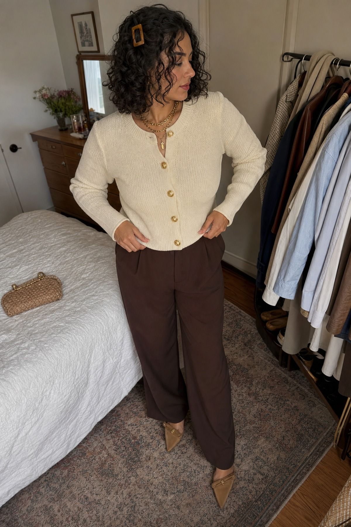 Woman wearing a gold button cardigan with wide leg pants, a glamoratti outfit