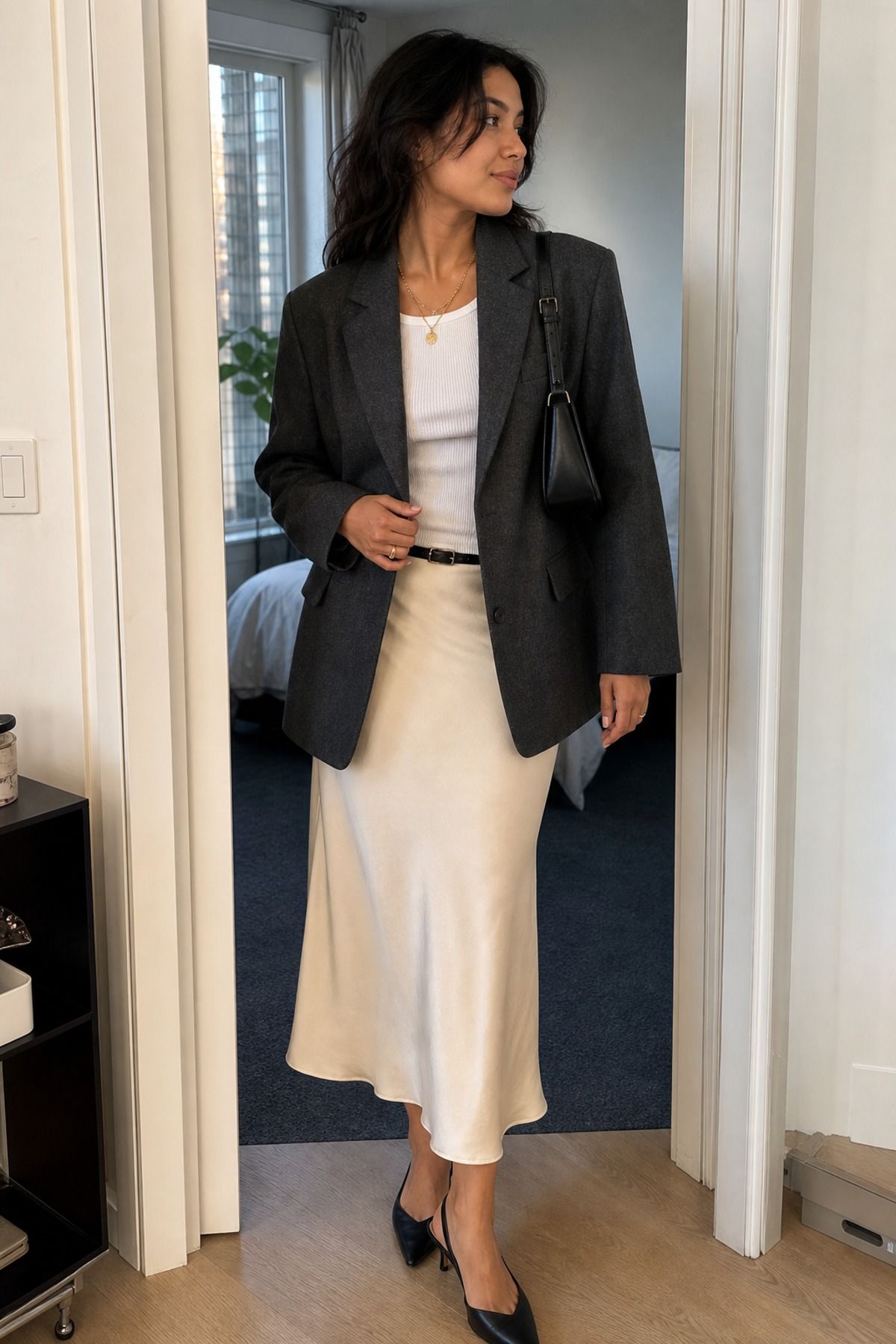 Woman wearing a boxy blazer with a satin slip skirt, a glamoratti outfit