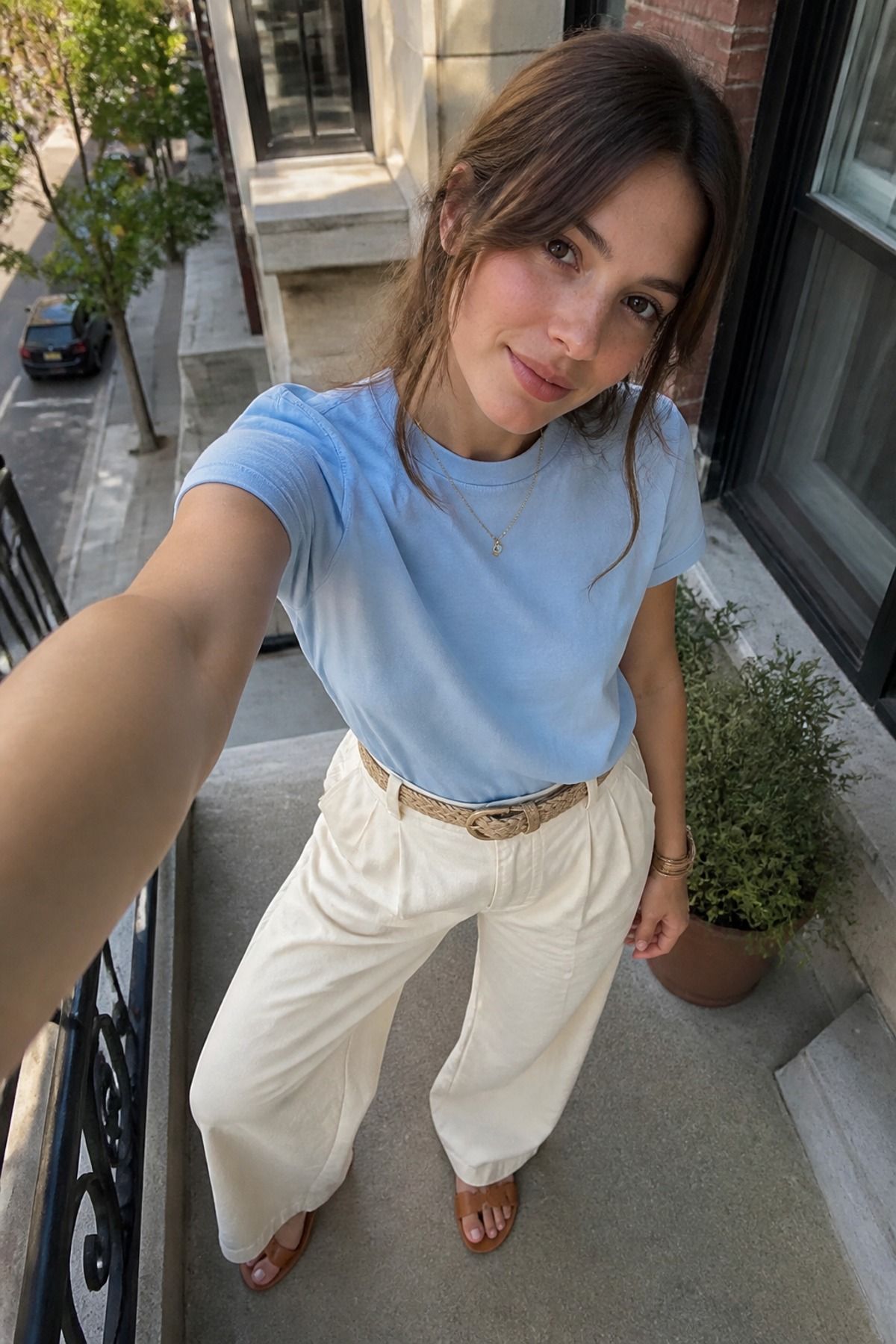 Woman wearing a powder blue tee with cream wide leg pants, an icy blue outfit