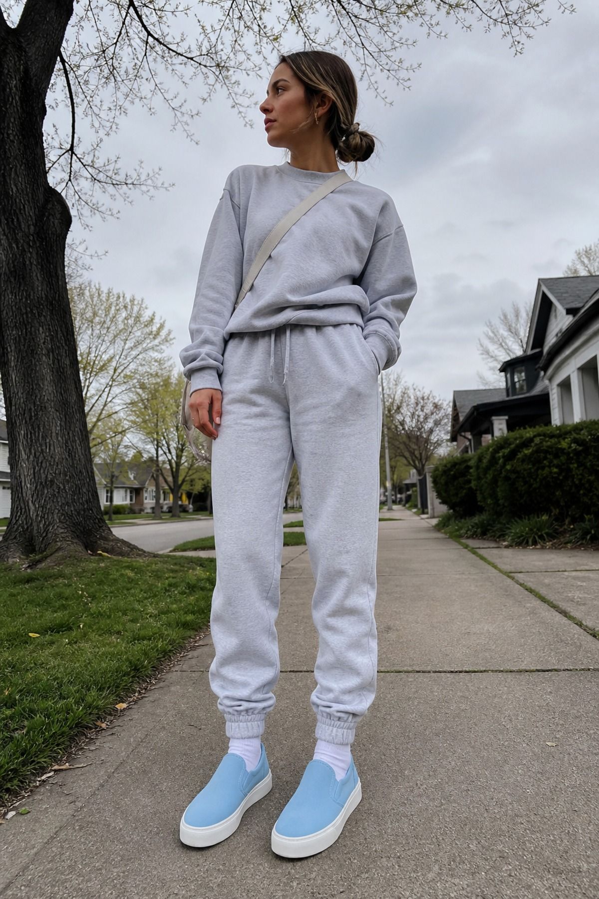 Woman wearing icy blue sneakers with a gray sweat set