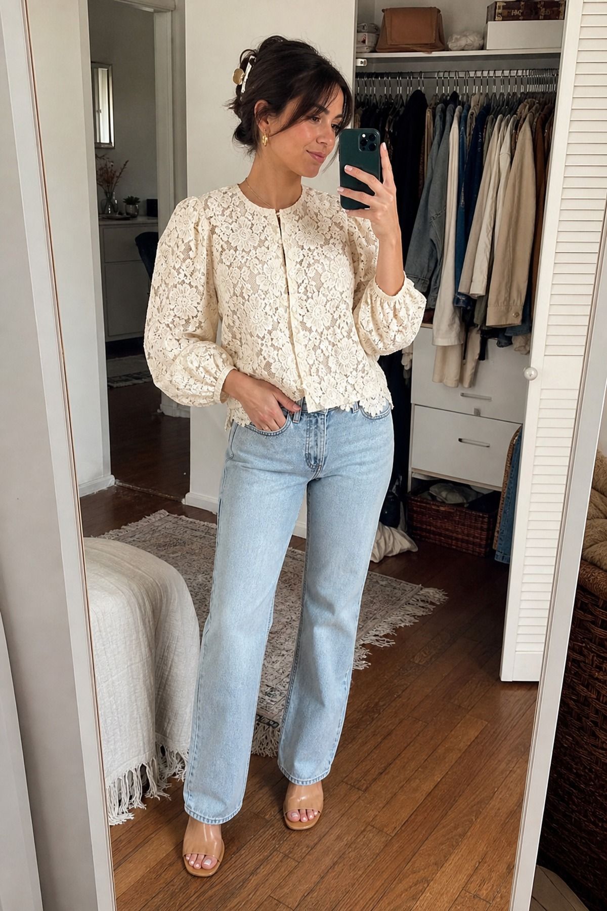 Woman wearing a cream lace blouse with light wash jeans